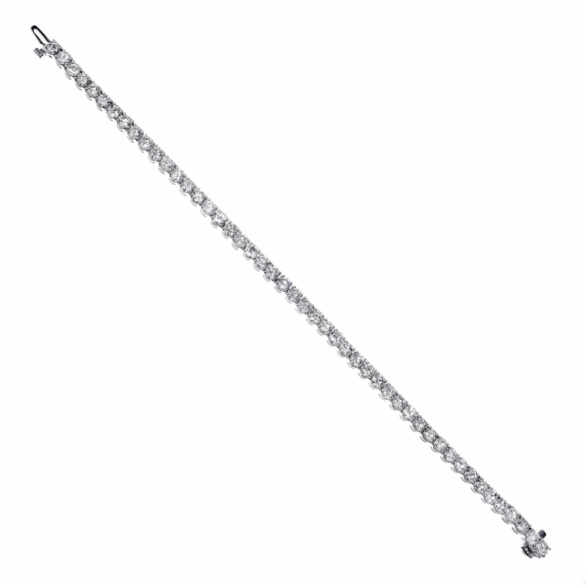 Bright round diamond 14k white gold tennis bracelet from the Peter Suchy Workshop.

48 round brilliant cut diamonds F-G SI-I, approx.  7.73cts
14k white gold 
Stamped: 14k
13.8 grams
Bracelet: 7 Inches
Width: 3.95mm 
Thickness/depth: 3.8mm

