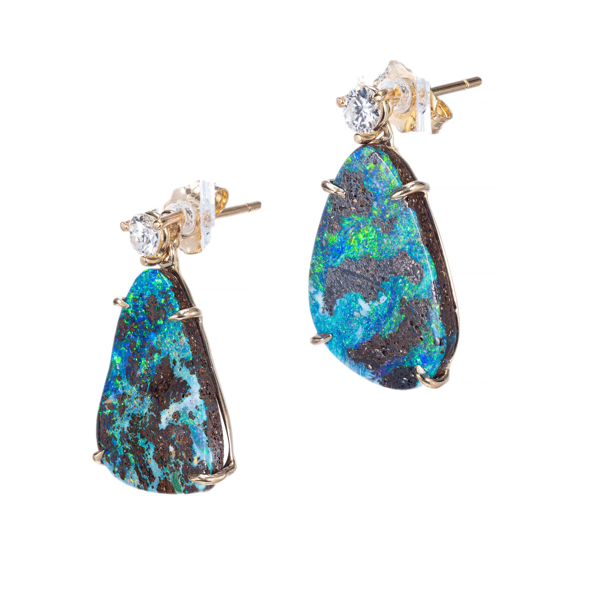 Free style shaped Opal and diamond earrings. Set in 14k yellow gold dangles. 2 opals with 2 round accent diamonds. 

2 fancy opals approx total weight: 7.95
2 round diamonds approx total weight: .23cts I , SI1 -SI2
Length: .84 inches or
