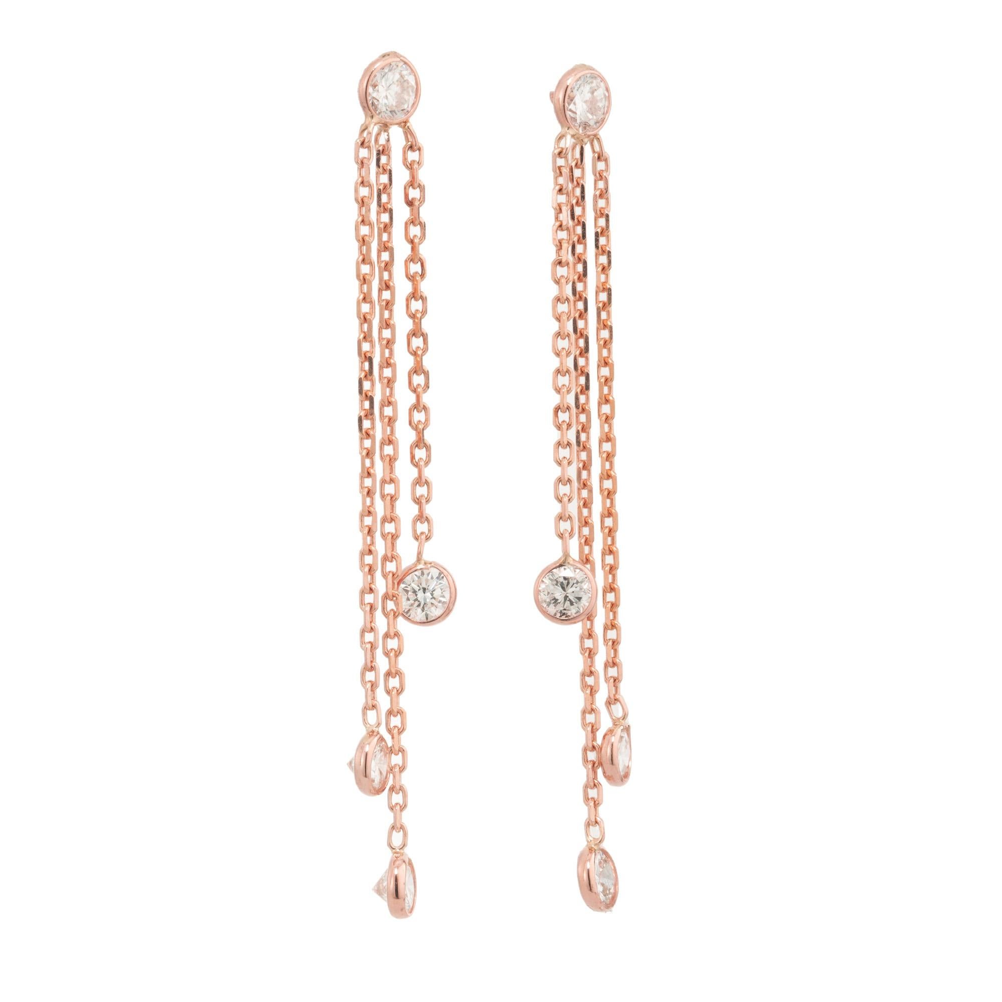 Immerse yourself in elegance with these exquisite Peter Suchy Diamond dangle drop earrings in Diamond by the Yard styling. 8 round brilliant cut bezel set diamonds, 3 of which dangle from three different length 14k rose gold chains. These dangle