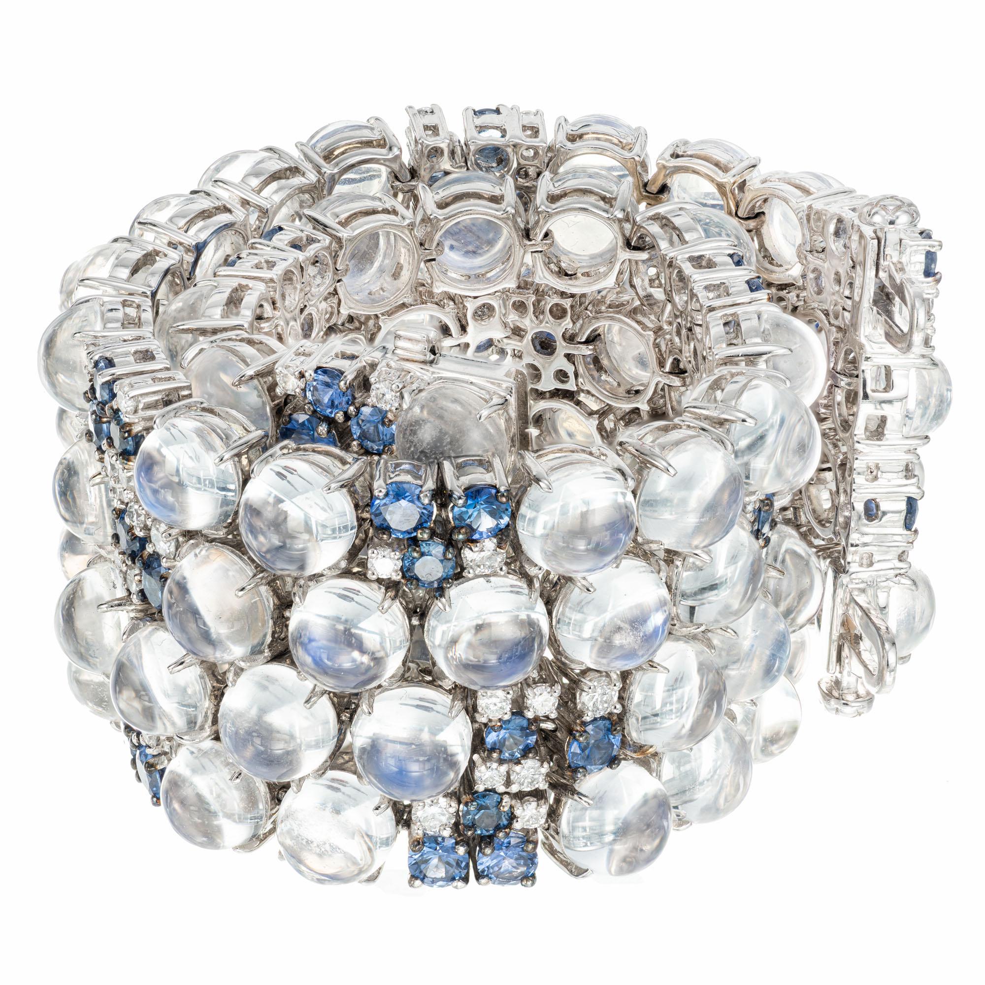 Moonstone, diamond and sapphire bracelet. 88 round cabochon moonstones accented with 66 round sapphires and 96 round brilliant cut diamonds inter mixed between the moonstones. The sapphires reflect into the moonstones causing a beautiful blueish/