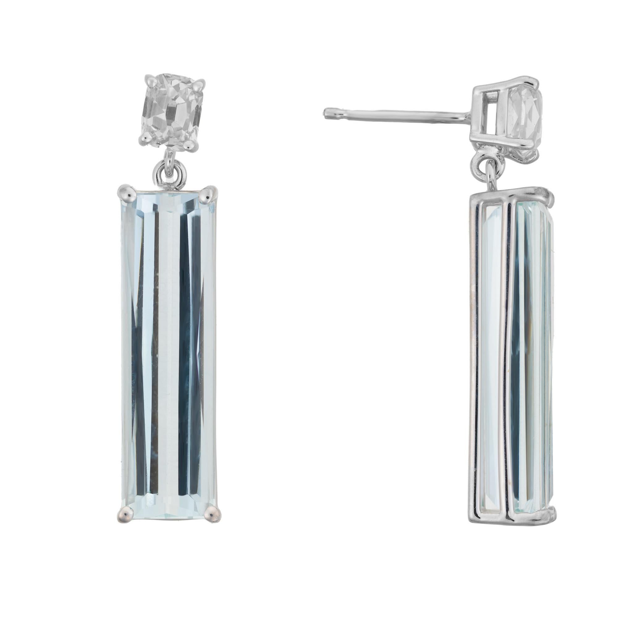 One of a kind aquamarine and diamond dangle earrings. 2 elongated emerald cut aquamarines, mounted in 14k white gold handmade settings accented with 2 custom shaped old mine cut diamonds. These aquas are a natural beautiful blue and slightly