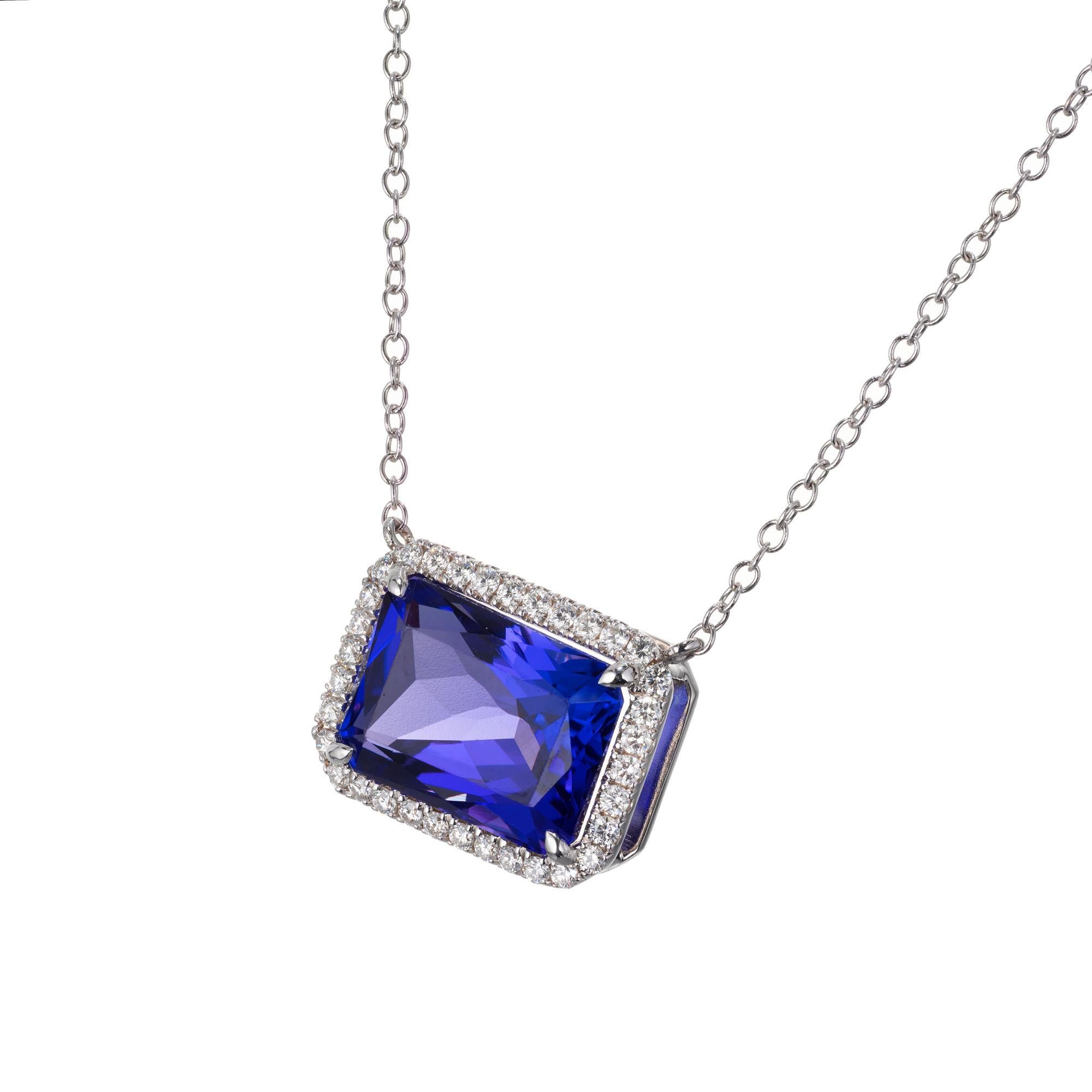Rectangular tanzanite and diamond pendant necklace. Blue tanzanite with a halo of round diamonds in 18k white gold. Created in the Peter Suchy Workshop.  

1 rectangular cut blue tanzanite VS, approx. 9.26cts
34 round brilliant cut diamonds G-H VS,