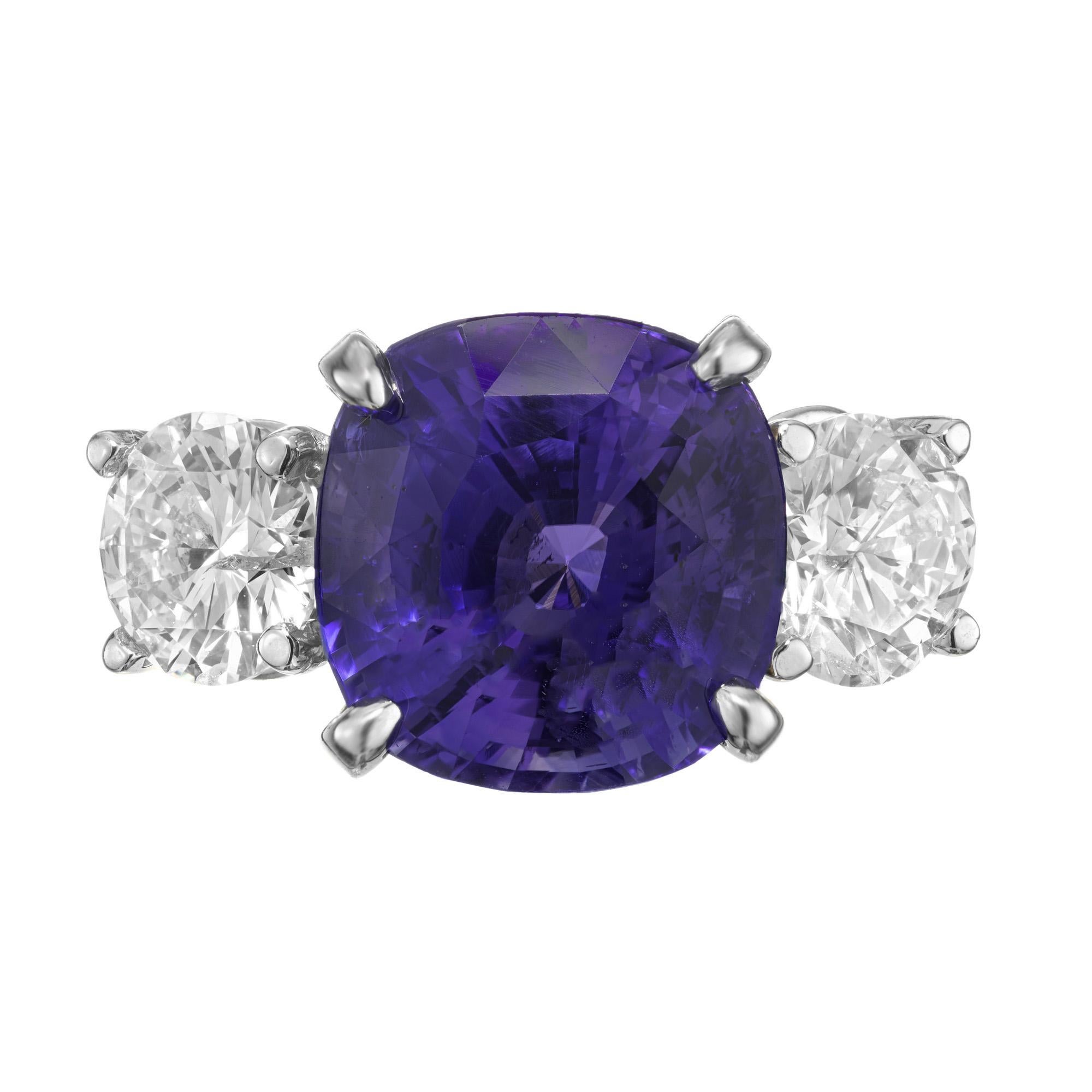 Spectacular Peter Suchy sapphire and diamond engagement ring. This stunning ring begins with a 7.72ct cushion cut rich blue sapphire. Certified by the AGL as natural, no heat. The sapphire is accented beautifully by two round brilliant cut side