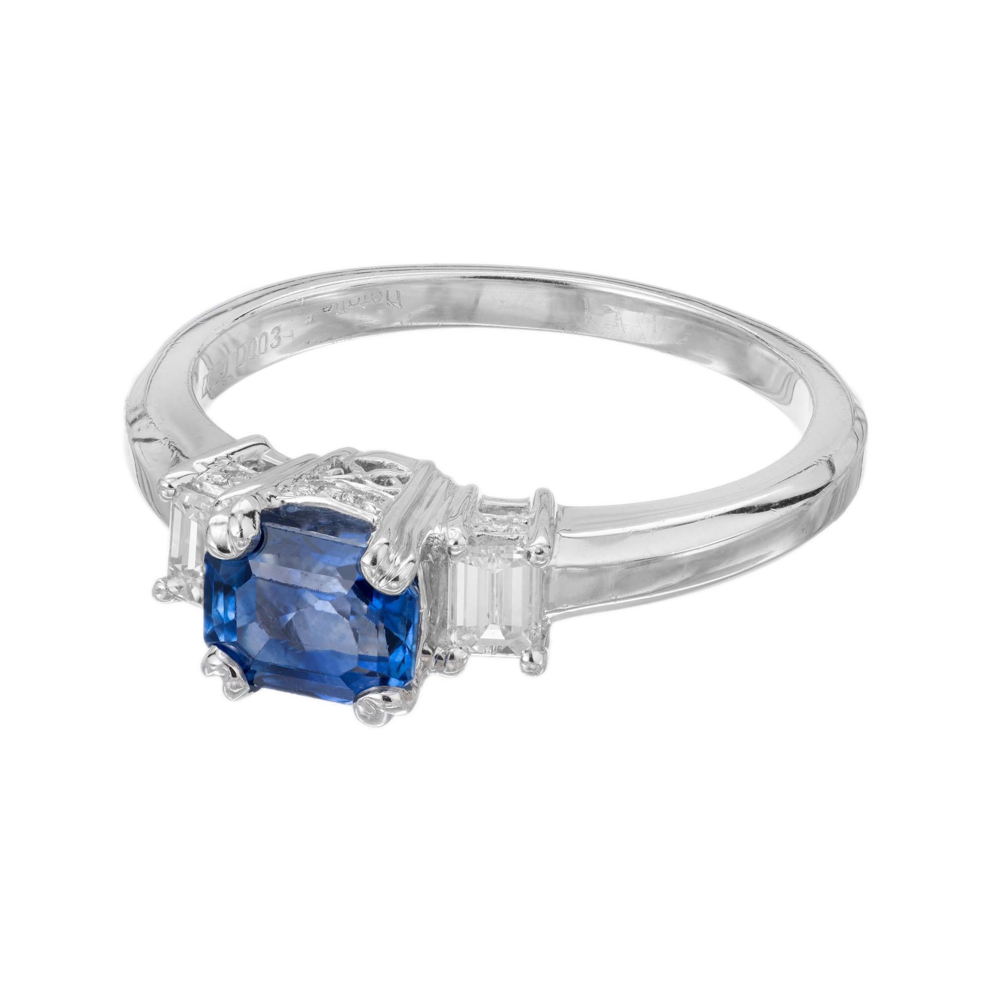 Vintage step cut blue sapphire and diamond engagment ring. AGL certified emerald step cut center stone set in a platinum three-stone setting with 2 emerald step cut diamonds and 8 full cut round accent diamonds. Created in the Peter Suchy Workshop.