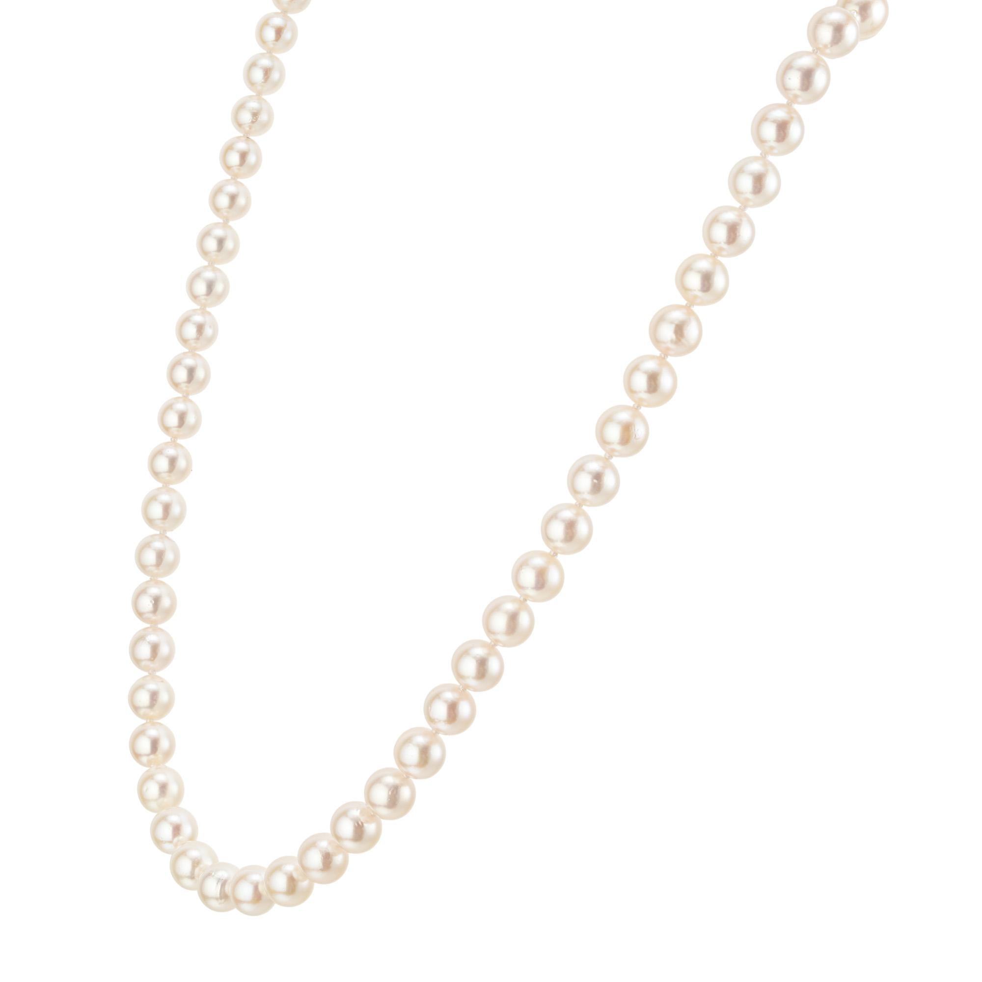 Akoya Japanese 7 mm to 7.7mm cultured pearl necklace. Each of the 58 round pearls are well matched with pink hue and high lustre. 18 inches in length, the pearls are perfectly complemented by the gentle sheen of the 14k white gold clasp. Draped