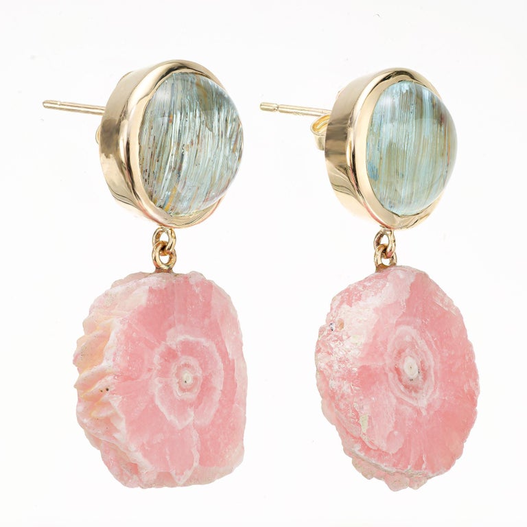 Aqua and Rhodochrosite dangle earrings. 2 natural round cabochon aqua crystal needle inclusions with 2 natural rhodochrosite dangles. Designed and crafted in the Peter Suchy workshop

2 pink rhodochrosite round slabs, approx. 28.5cts
2 round bluish