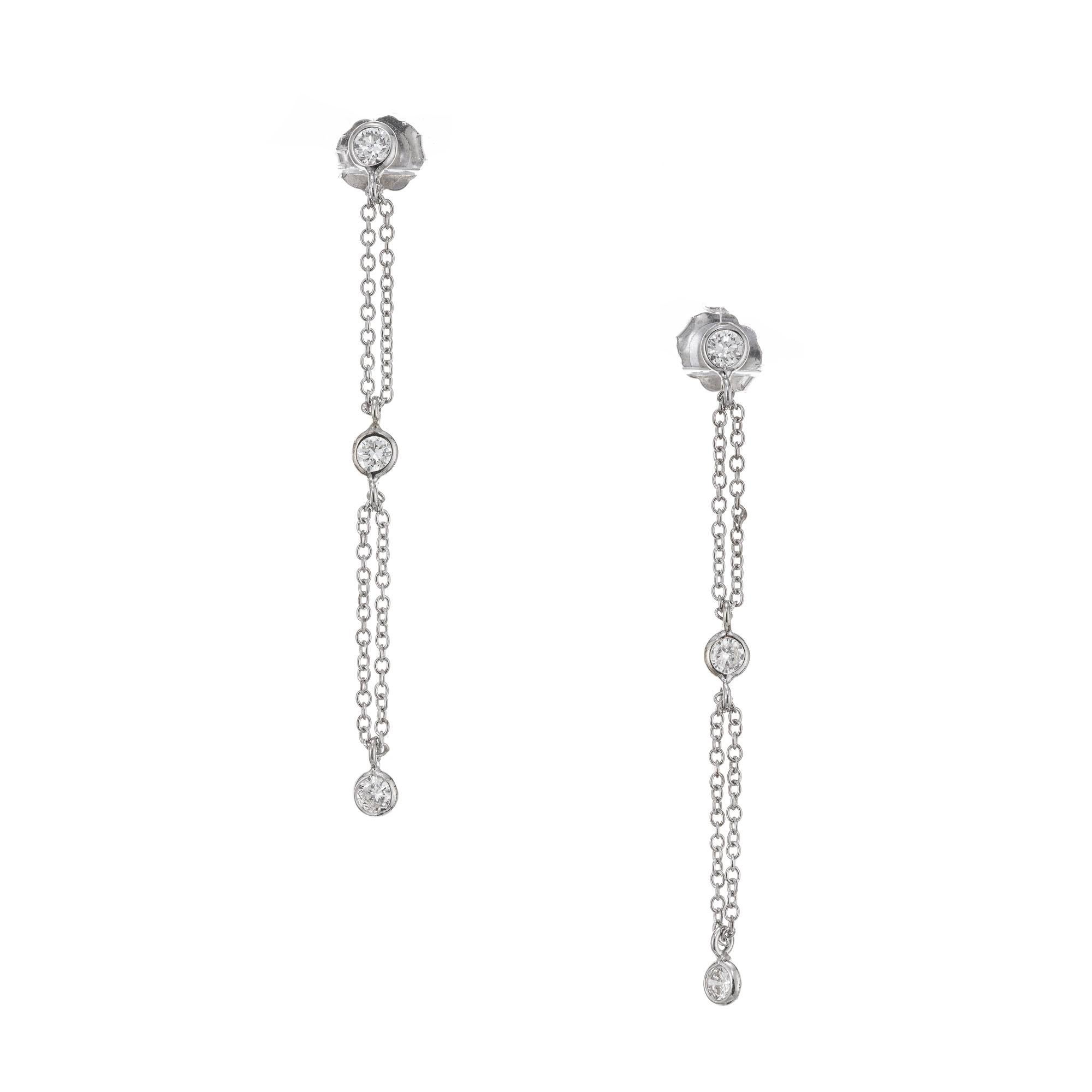 Peter Suchy diamond by the yard style dangle earrings. 6 Bezel set diamonds connected by a continuous loop of double chain that floats freely through the jump ring on the diamond. Bezels are 3.3mm and the chain is 1mm.

6 round full cut diamonds,