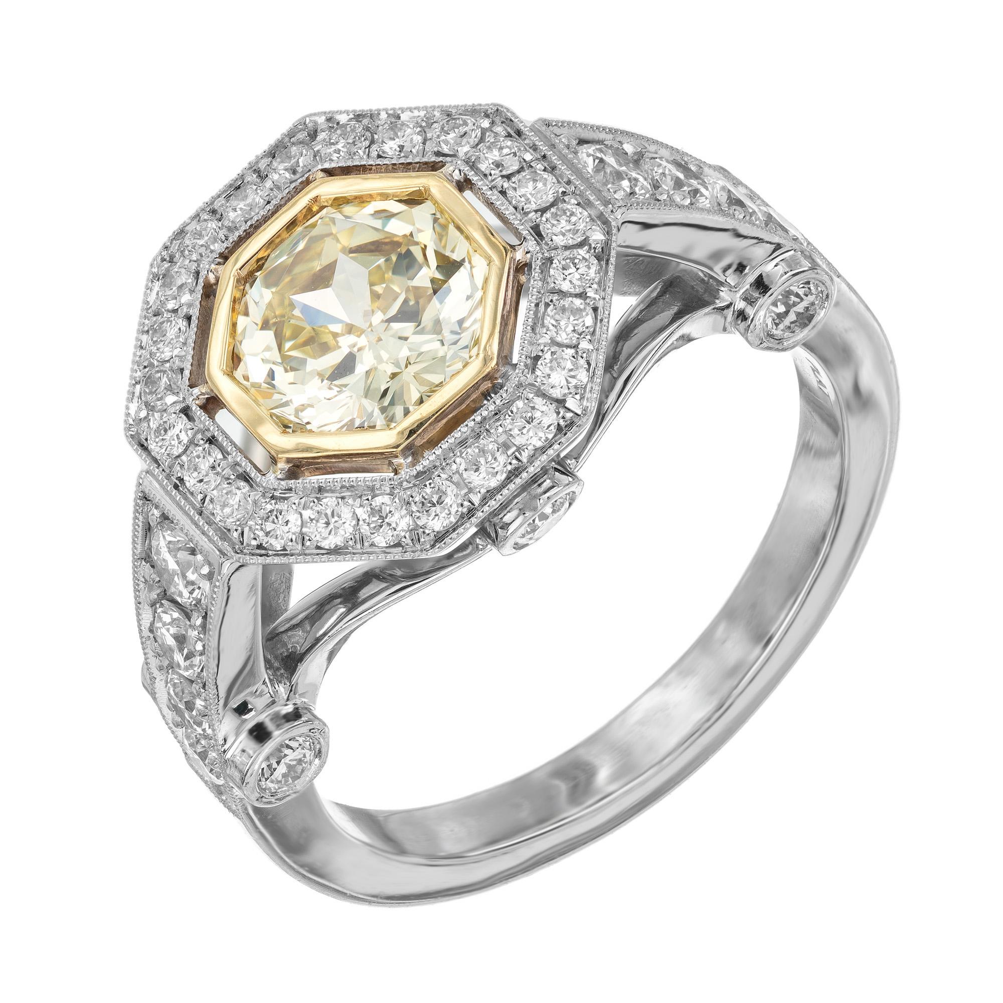 Light natural yellow diamond platinum engagement ring. Spectacular 8 sided yellow 1.12ct center diamond which is bezel set in 14k yellow gold. The diamond is mounted in a platinum setting and accented with a halo of round full cut diamonds. Each