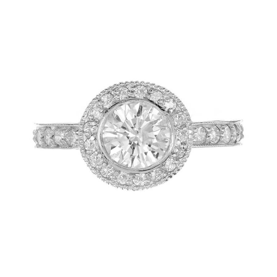 Peter Suchy Micro-pave diamond solid Platinum engagement ring. This exquisite piece features a dazzling 1.01 carat round bezel set center diamond that catches the light with every turn, creating a dance of brilliance and fire that is sure to