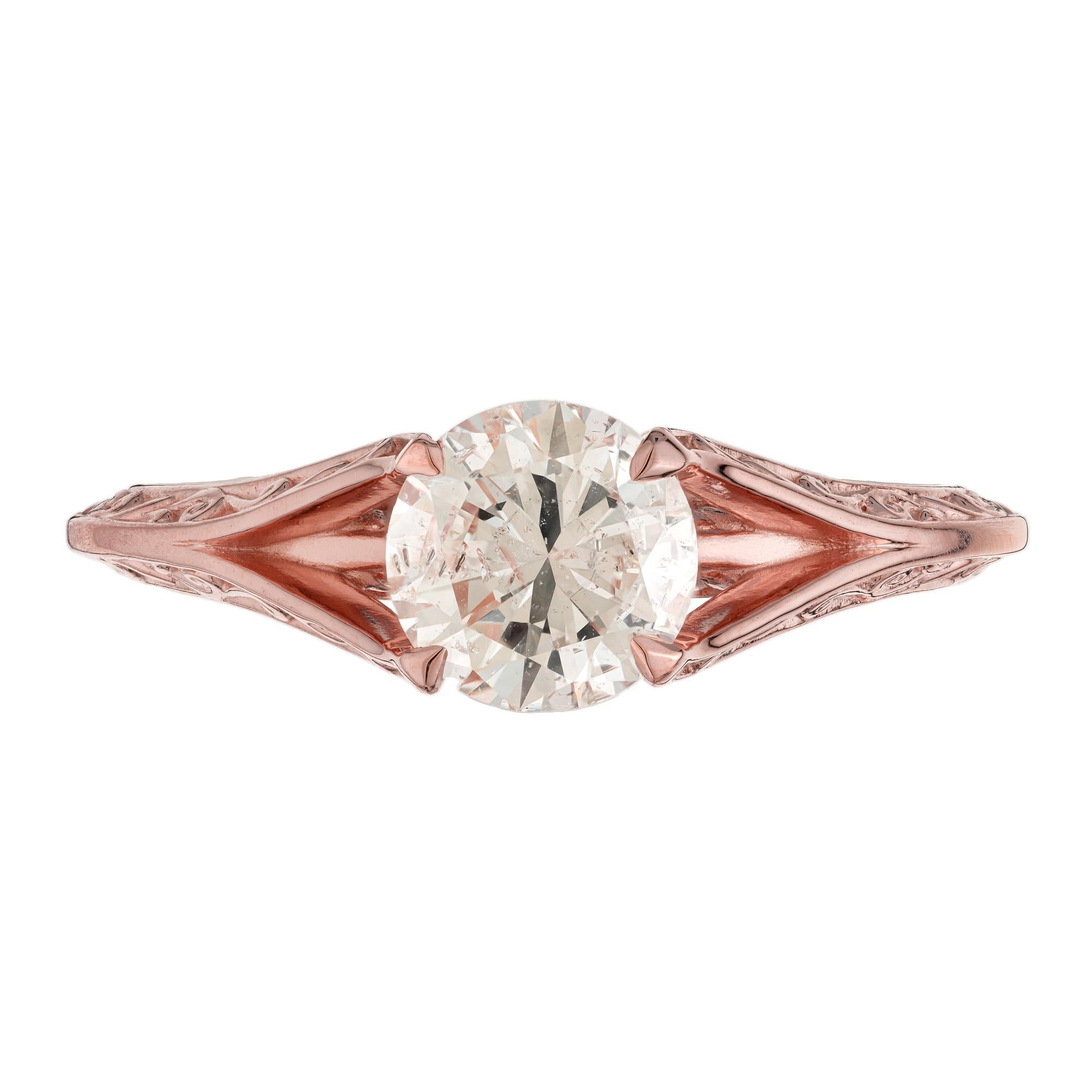 Solitaire style diamond engagement ring. Set with a 1.05ct round center stone in a 14k rose gold split shank mounting. This four prong ring is etched beautifully with precision detailing. The simplicity of the solitaire design allows the diamond to