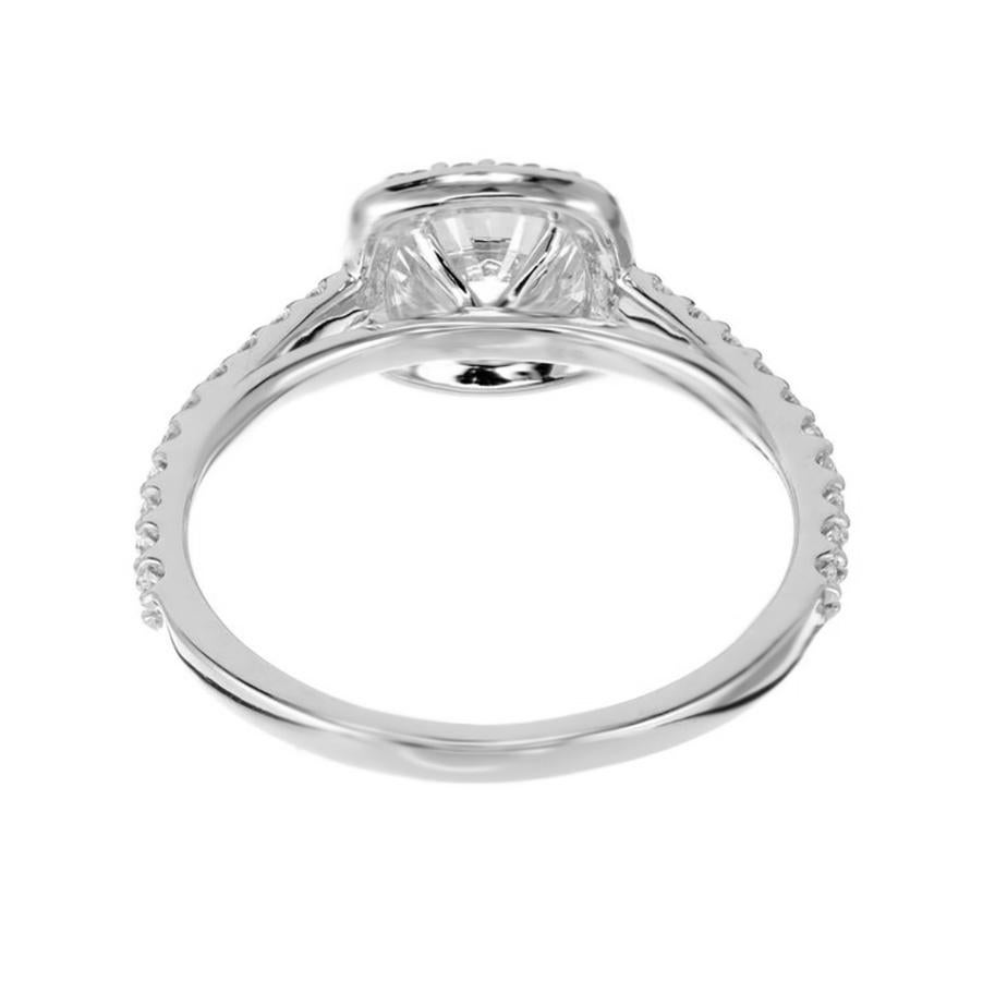 Peter Suchy round halo style engagement ring. This exquisite piece features a striking 1.18 carat round brilliant cut center diamond which is encircled by a shimmering halo of round full cut diamonds that enhances its natural radiance. Nestled in a