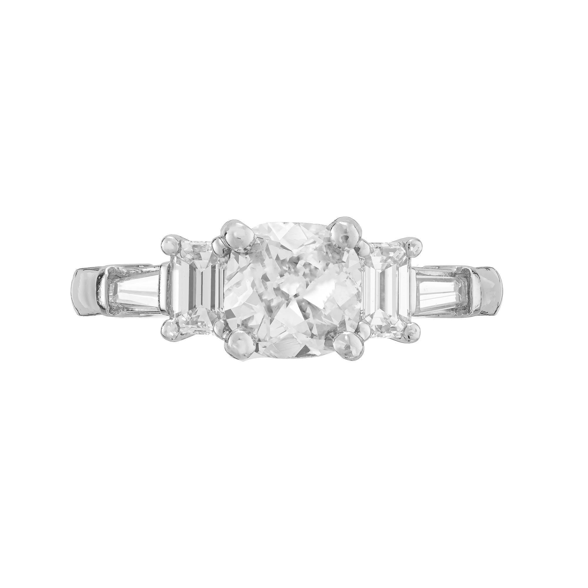 Diamond engagement ring. EGL certified cushion cut center diamond with 2 emerald cut and 2 tapered baguette side diamonds, set in platinum. The stones are circa 1900.  Raised crown and a small table. The setting was created in true Art Deco style