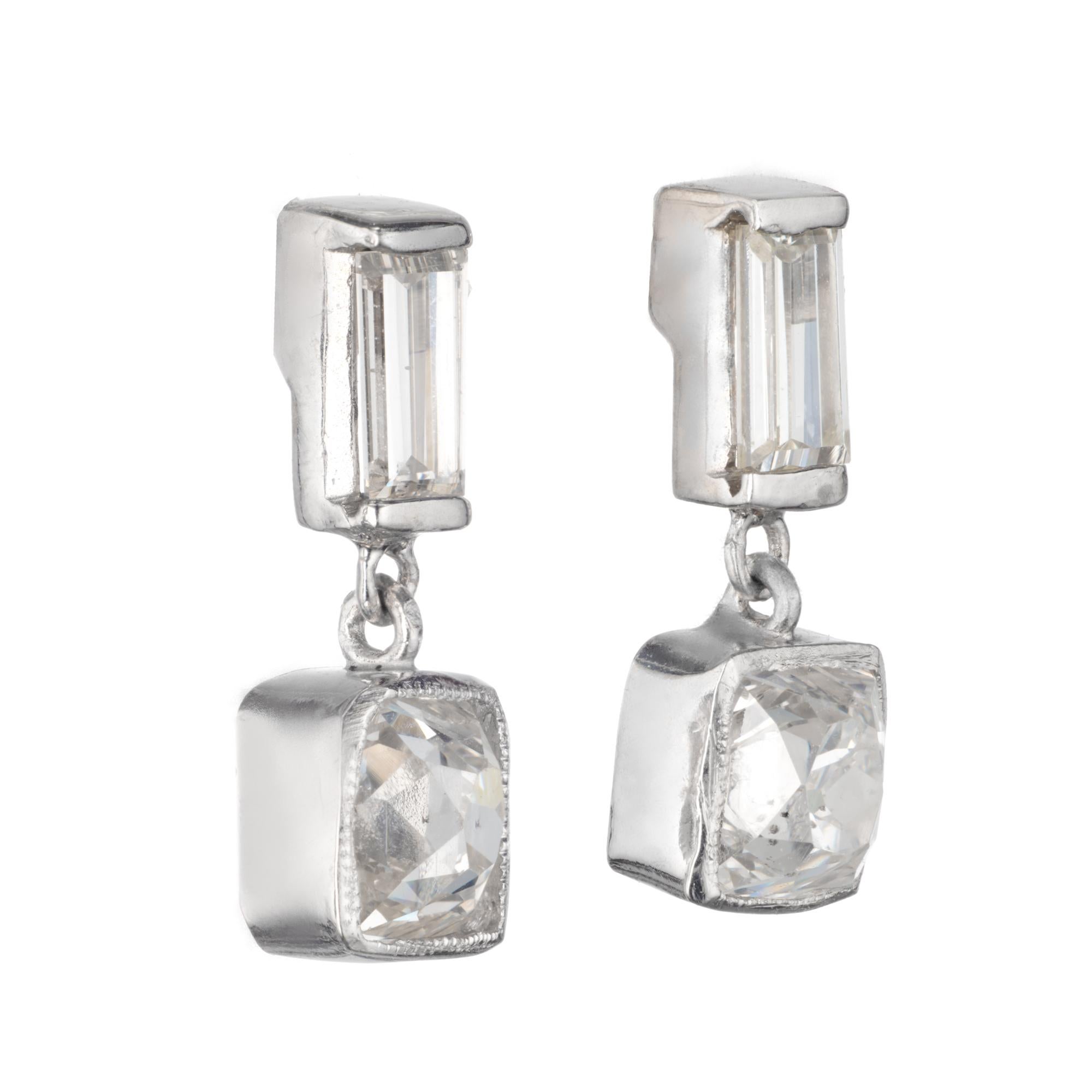 Estate old mine brilliant cut diamonds with baguette diamond tops made into platinum dangle earrings by the Peter Suchy Workshop

1 old mine cut H-I SI diamonds, Approximate .52cts EGL Certificate # US400123990D
1 old mine cut G-H SI diamonds,