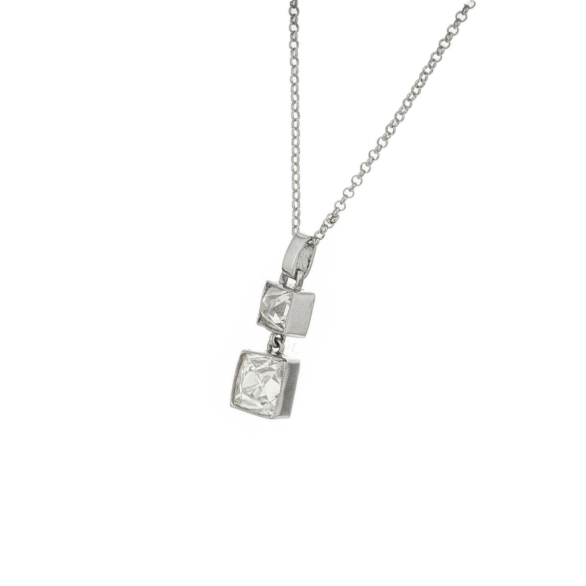 Custom made diamond dangle pendant necklace. 2 old mine cut diamonds that are bezel set in platinum one on top of the other connected by links with a 20 Inch platinum link chain with a lobster clasp. Designed and crafted in the Peter Suchy