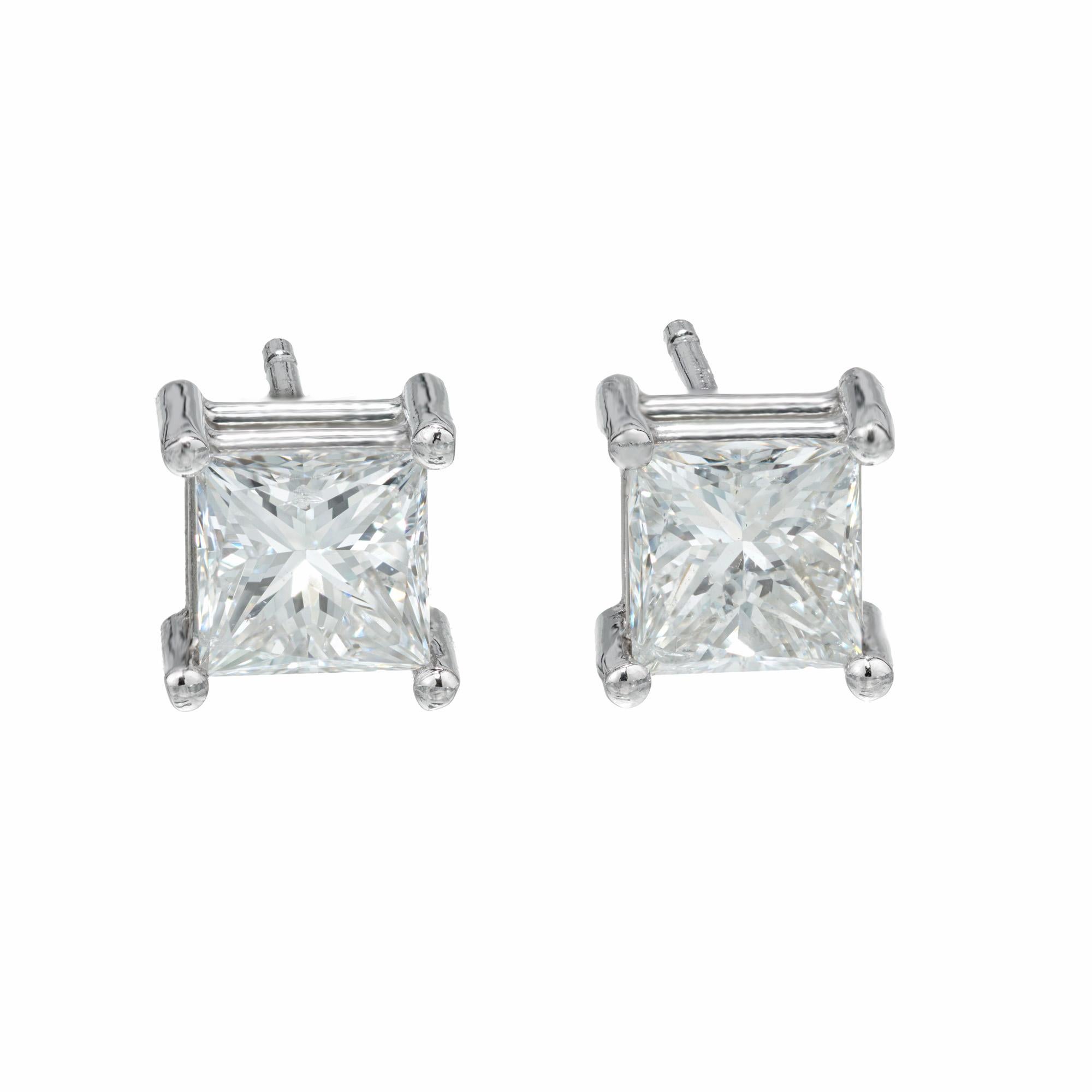 Bright, white and colorless princess cut diamond stud earrings. 2 EGL certified, E-F colorless square cut diamonds set in simple 4 prong platinum basket settings. Designed and crafted in the Peter Suchy Workshop.

2 square modified brilliant cut