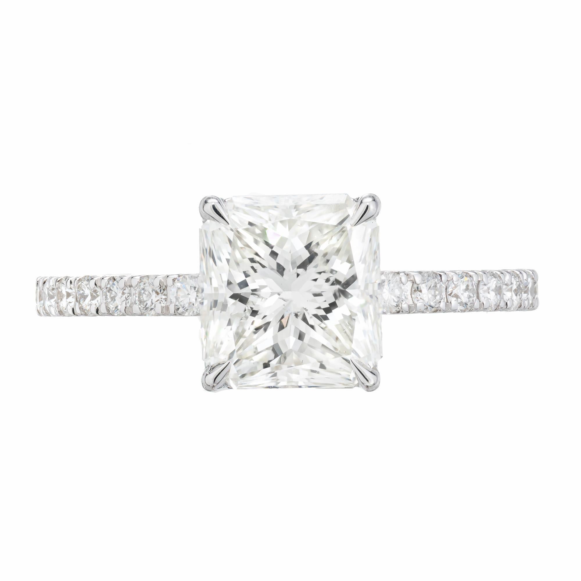 Simple elegance. Radiant cut diamond engagement ring. This radiant brilliant cut 2.24ct diamond is mounted in a four prong 18k white gold setting. Accented with 22 round brilliant cut diamonds along each side of the shank. The center diamonds is