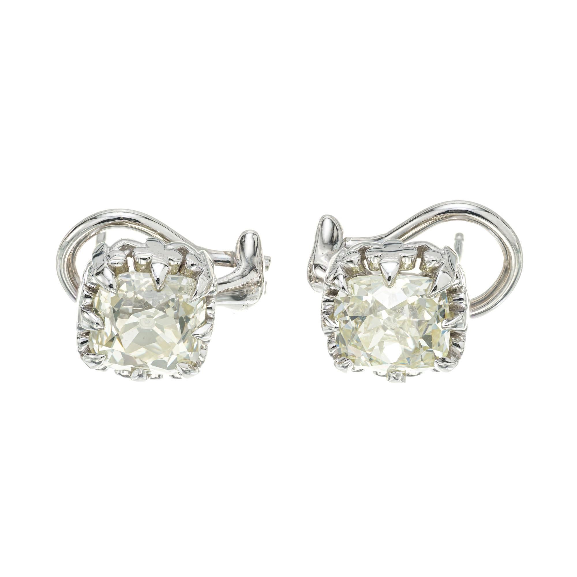 Peter Suchy antique inspired platinum diamond stud earrings with a low set scroll design top that is a copy of a 1900’s hand made earring. Set with two EGL certified old mine brilliant cut diamonds. The post is platinum, and the clip backs are 18k