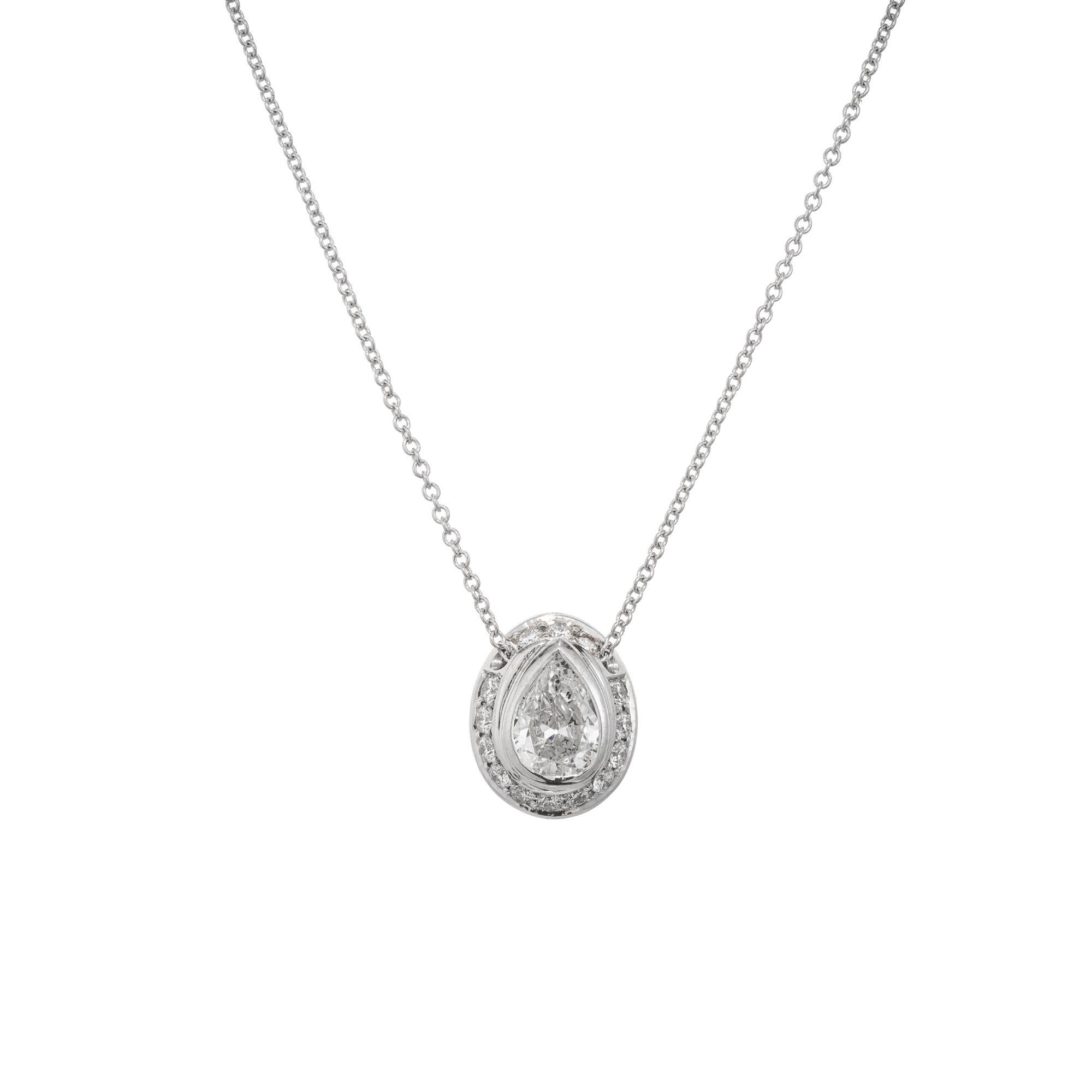 Custom made oval Diamond halo slide pendant necklace. EGL certified near colorless,  69ct pear shaped diamond, mounted in a bezel set 18k white gold setting. Accented with a halo of 13 round cut diamonds. 18 inch 18k white gold chain. Designed and