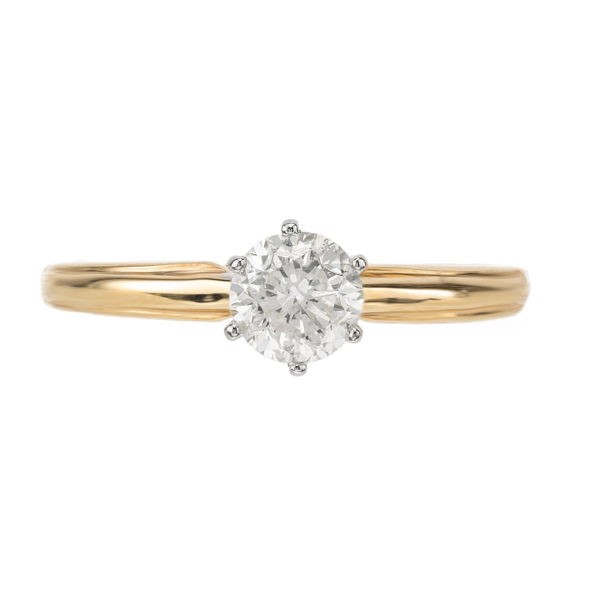 A timeless simple yet elegant EGL Certified diamond solitaire two tone gold engagement ring. Crafted with precision and elegance, this ring features a dazzling .73 carat round brilliant cut diamond set in a 14k white gold six prong crown and 14k