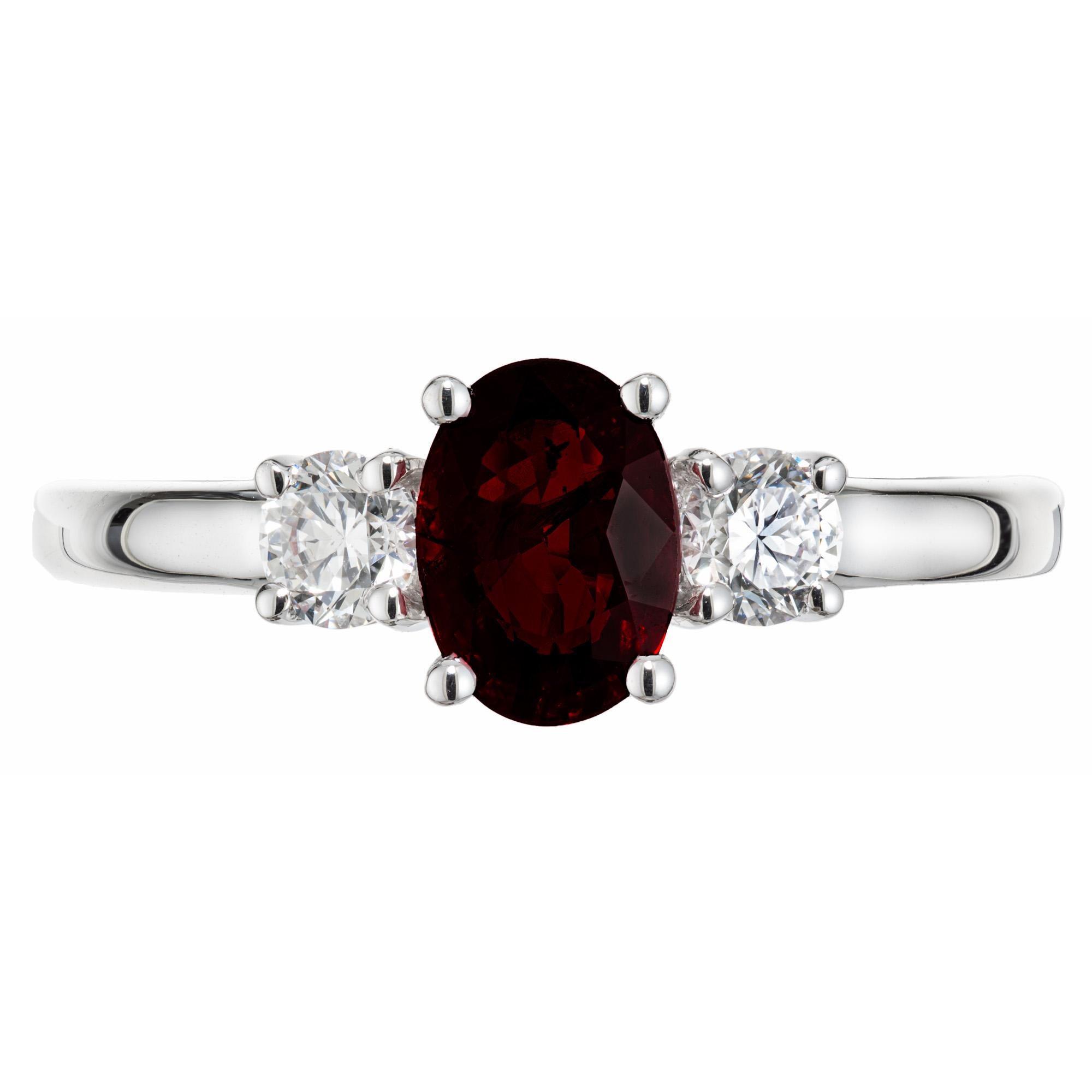 Simple and elegant ruby and diamond engagement ring. GAL certified oval natural no heat ruby center stone mounted in a three-stone 18k white gold setting. The ruby is accented by a round cut diamond on each side. This ring was designed and crafted