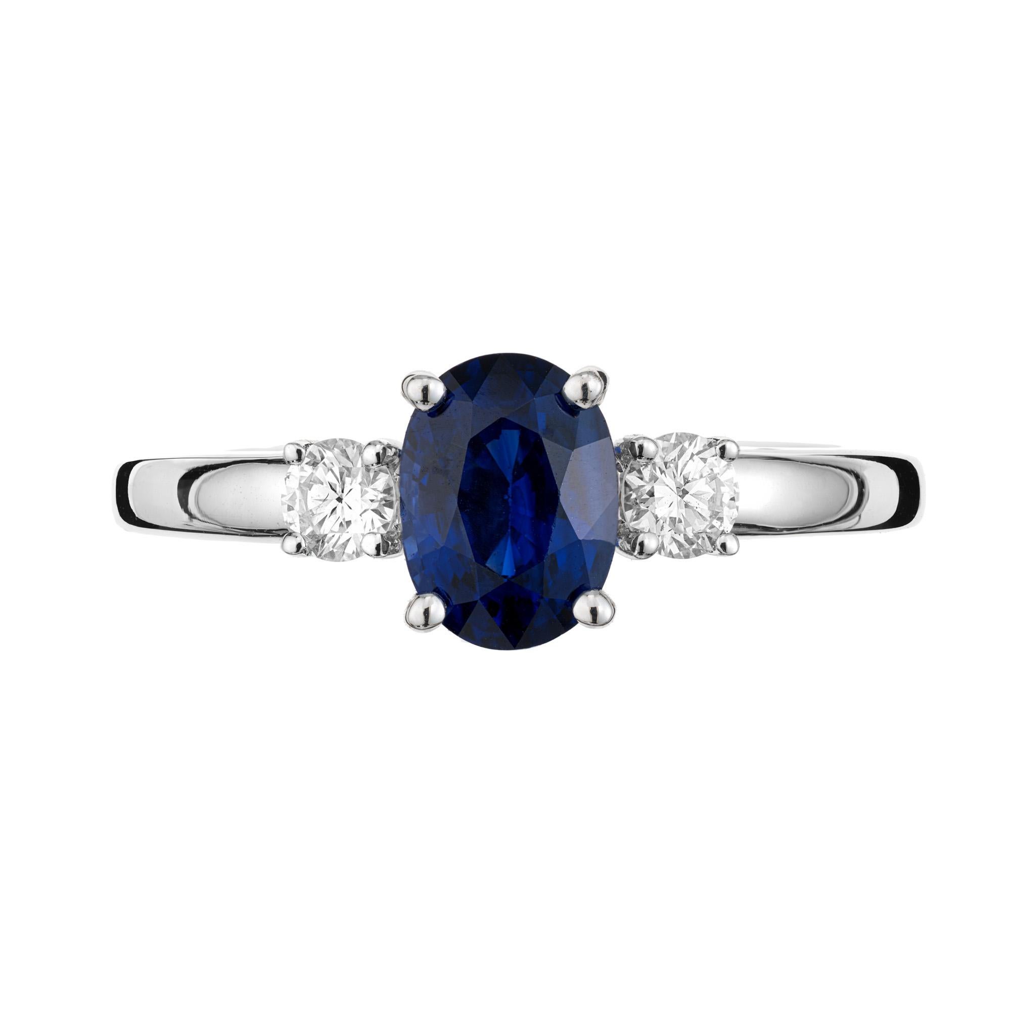 This Peter Suchy original GIA certified 1.00ct sapphire diamond three stone engagement ring is both classic and timeless. It features a beautiful oval-cut sapphire center stone. The sapphire has a deep rich blue hue. Certified by the GIA as simple