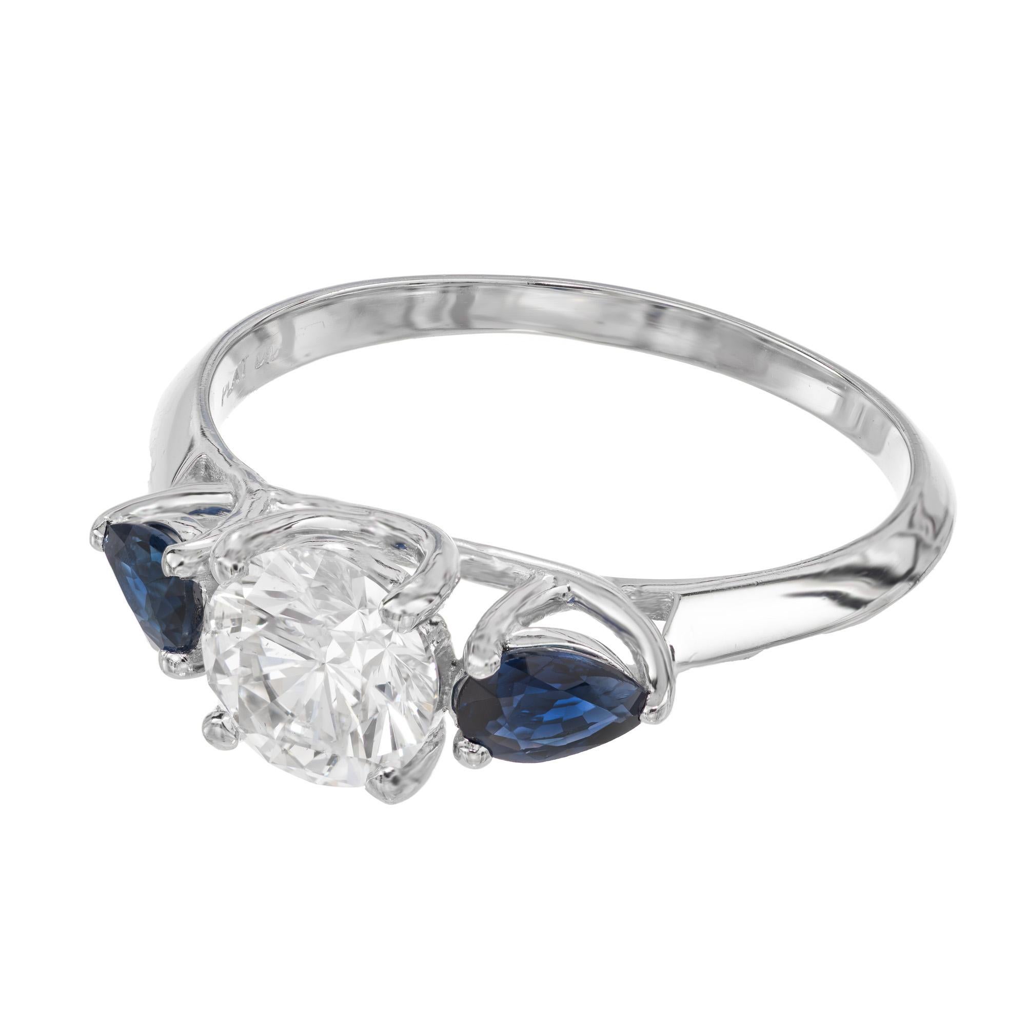Peter Suchy custom made 1.03 carat GIA certified round diamond and sapphire platinum engagement ring. This ring has a beautiful bright natural round diamond center stone which is complemented by 2 pear shaped sapphires with a total weight .50