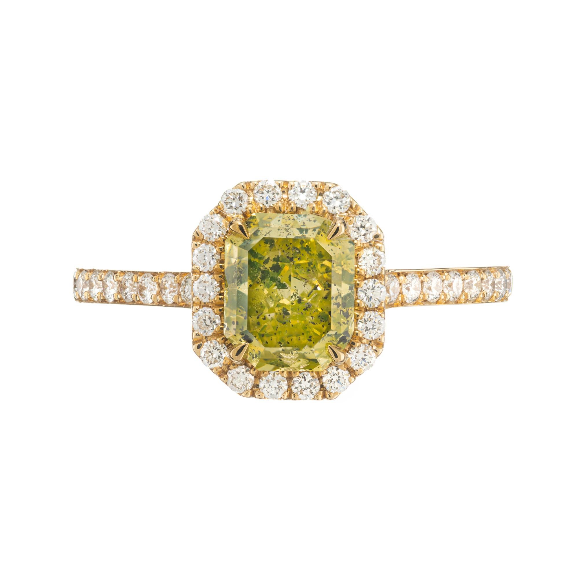 This Peter Suchy green yellow diamond engagement ring is a masterpiece that combines elegance with a touch of uniqueness. With a dazzling green yellow 1.27ct rectangular emerald cut center diamond as the focal point, it is enhanced by a halo of
