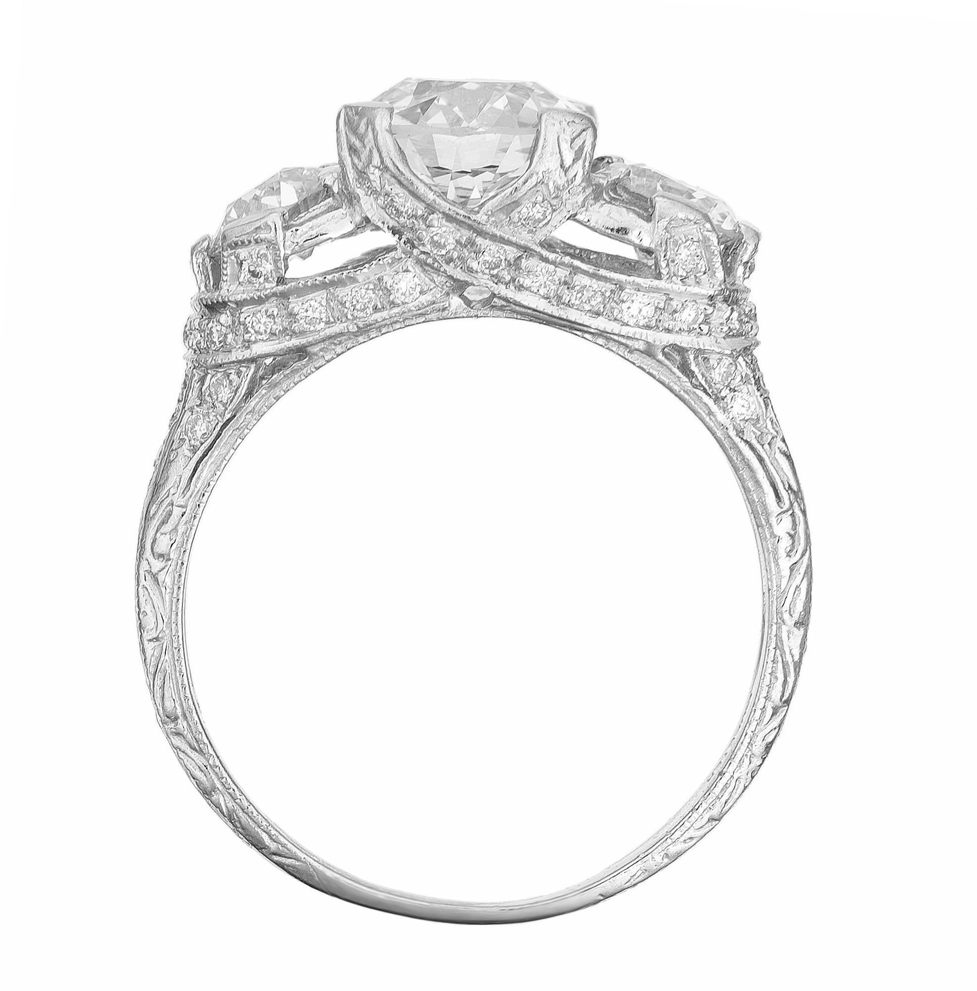 This Peter Suchy custom made diamond three-stone engagement ring features a stunning 1.58-carat Old European cut diamond as the focal point, GIA certified as near colorless. Accented by 2 Olde European brilliant cut side diamonds. Adding to the