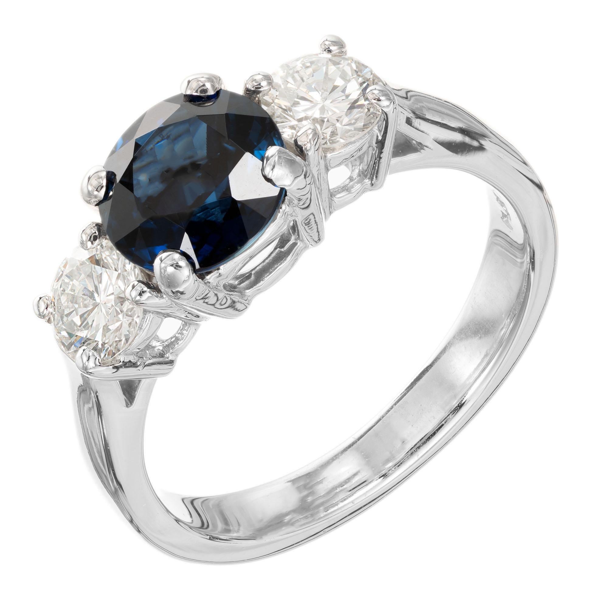 Sapphire and diamond three-stone engagement ring. GIA Certified natural no heat center sapphire with two round accent brilliant cut diamonds in a platinum setting from the Peter Suchy Workshop.  

1 round blue sapphire, SI approx. 1.91cts GIA