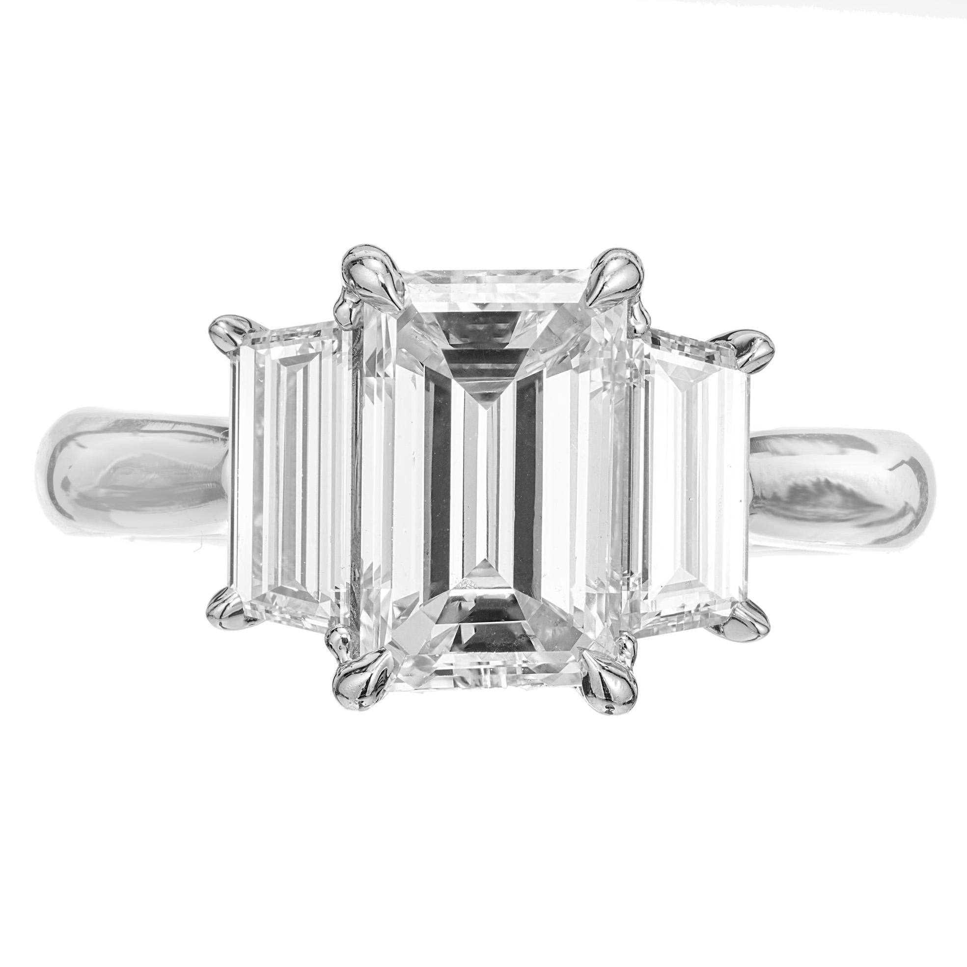 Diamond engagement ring. GIA certified 2.41ct emerald cut diamond in a platinum three-stone setting with two elongated step cut trapezoid side diamonds. Created in the Peter Suchy Workshop. 

One emerald cut diamond, approx. total weight 2.41cts, F,
