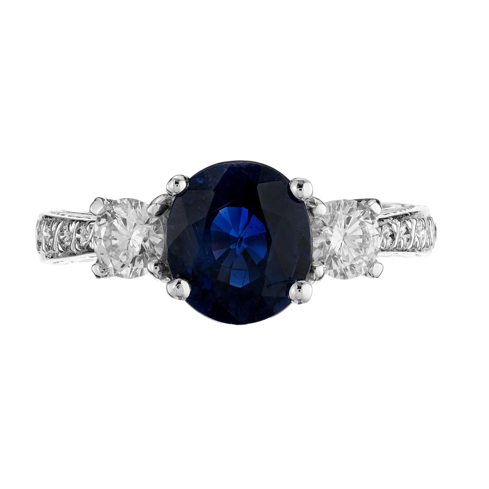Stunning oval sapphire and diamond three stone engagement ring. Set with a 2.48 carat natural, no heat, and blue oval GIA certified sapphire mounted in a carefully crafted platinum engagement setting. Accented by a bright round cut diamond on each