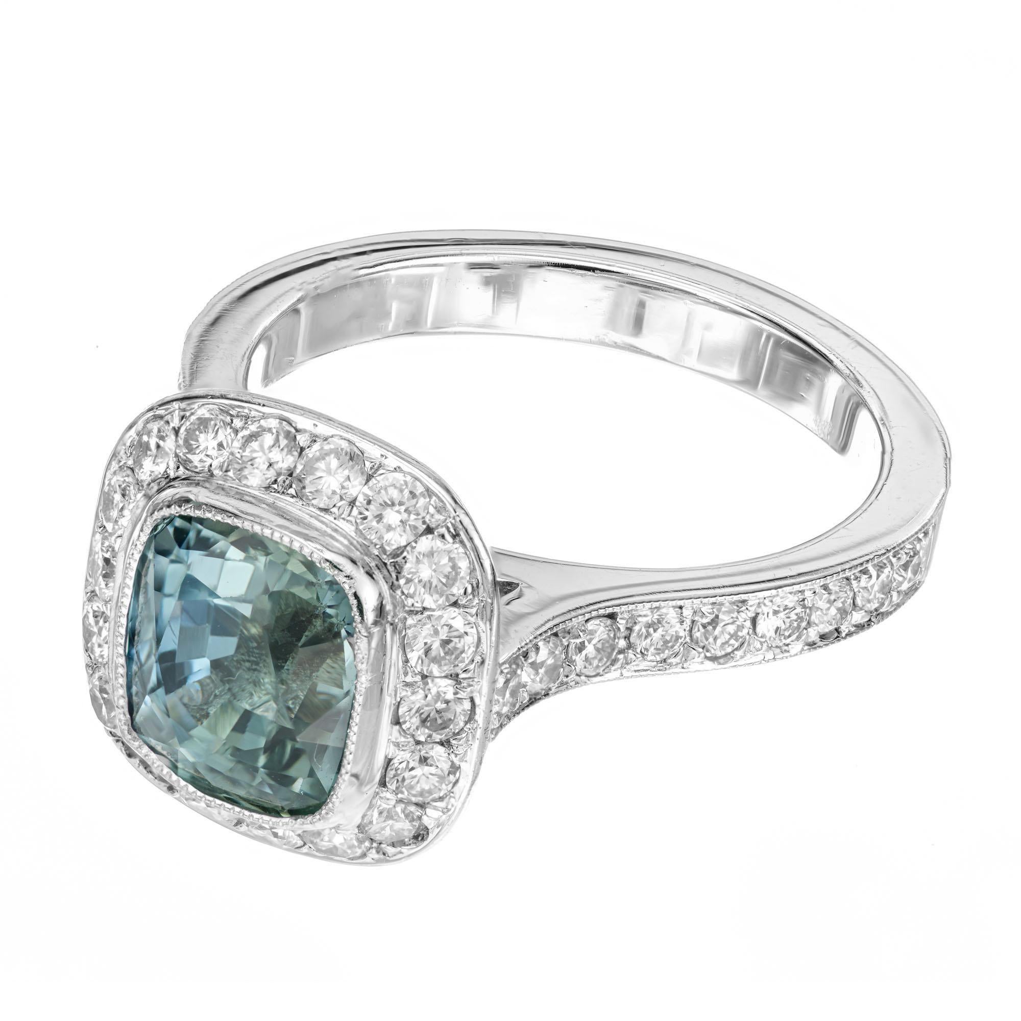 Blue and green sapphire and diamond engagement ring. GIA certified 3.20 carat natural no heat center cushion cut sapphire with 48 round ideal cut diamonds in a platinum halo setting. Both shoulders of the shank are also adorned with round cut