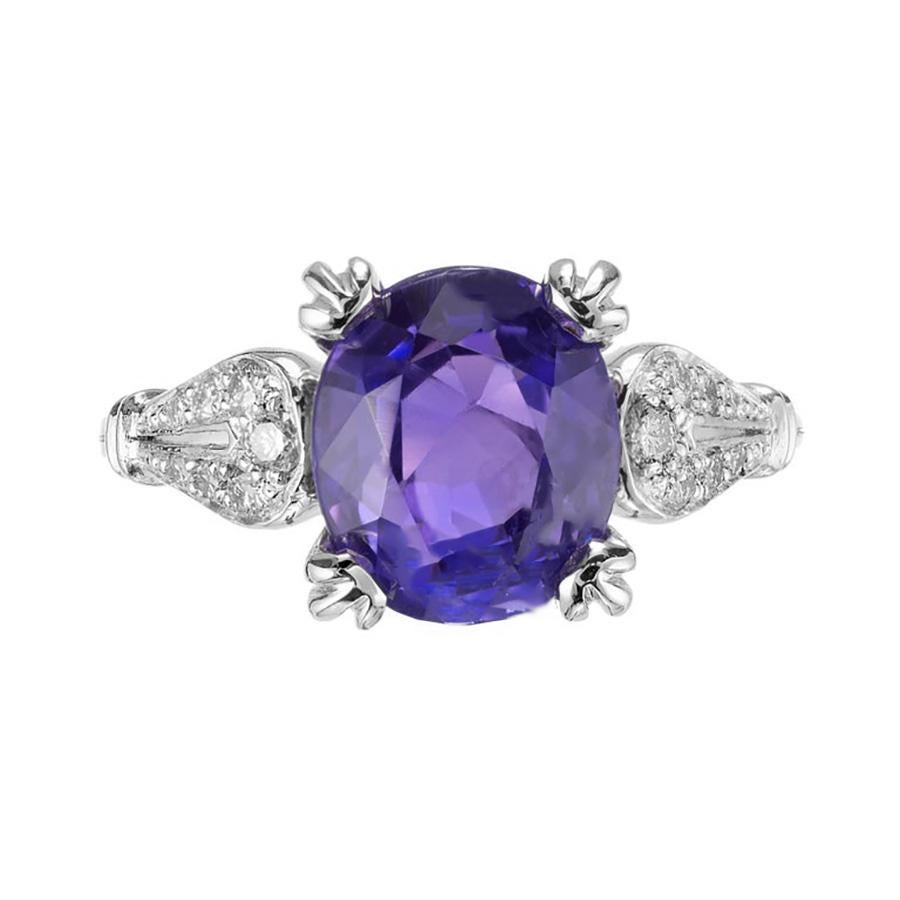 Exquisite 3.22 Carat violet sapphire diamond engagement ring is a true masterpiece. The vivid violet oval sapphire steals the spotlight, exuding a mesmerizing allure, while the 14 round brilliant cut diamonds that surround it add a touch of elegance