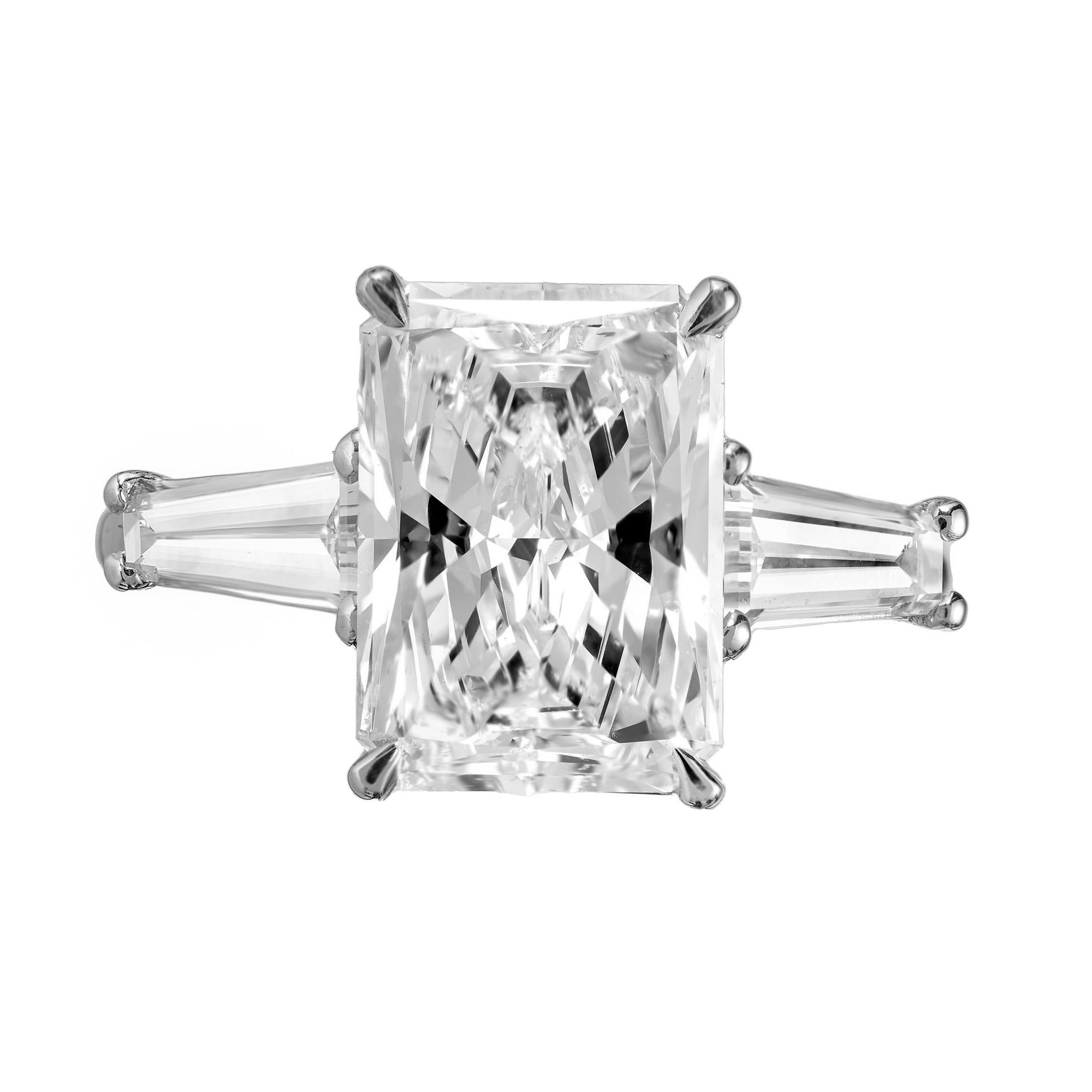 The Peter Suchy GIA certified 4.01ct diamond three stone platinum engagement ring, is an exquisite masterpiece that embodies timeless elegance. At the heart of this breathtaking piece are three carefully selected diamonds, each radiating with