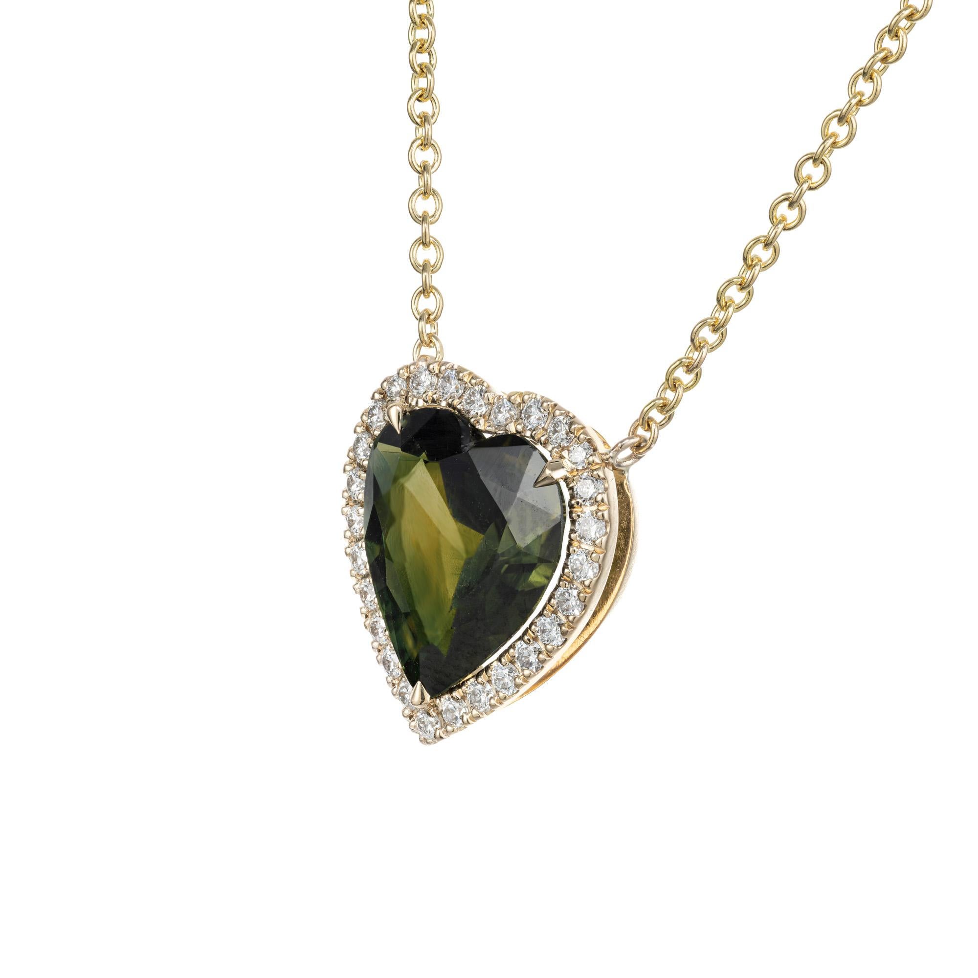 Sapphire and diamond pendant necklace. 4.98 Carat GIA certified heart shaped green sapphire with a halo of 27 round brilliant cut diamonds. 18k yellow gold setting with an 18 inch chain. Designed and crafted in the Peter Suchy workshop.

1 heart