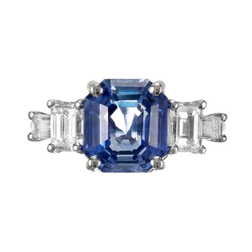 Sapphire and diamond engagement ring. GIA certified 6.05ct natural no heat center octagonal Sapphire set in a platinum setting accented with two emerald cut diamonds and two baguette cut diamonds. Designed and crafted in the Peter Suchy Workshop. 