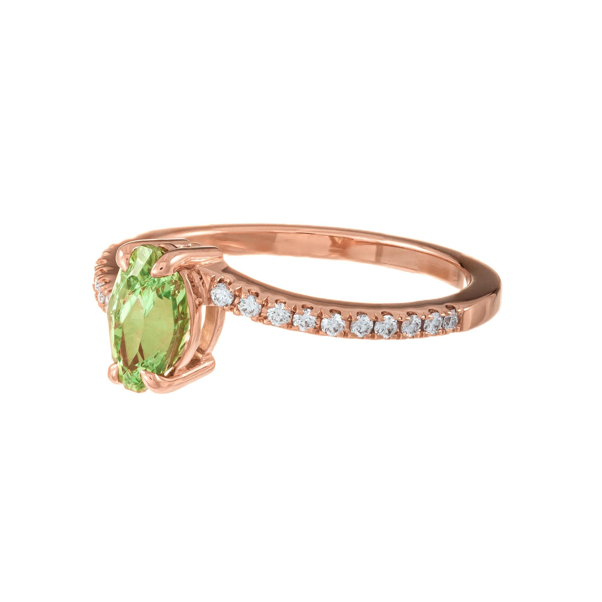 Bright green Tsavorite garnet and diamond engagement ring. GIA certified marquise center Tsavorite with 20 round accent diamonds in a 14k rose gold setting. Created in the Peter Suchy Workshop  

1 marquise yellowish green tsavorite garnet, approx.