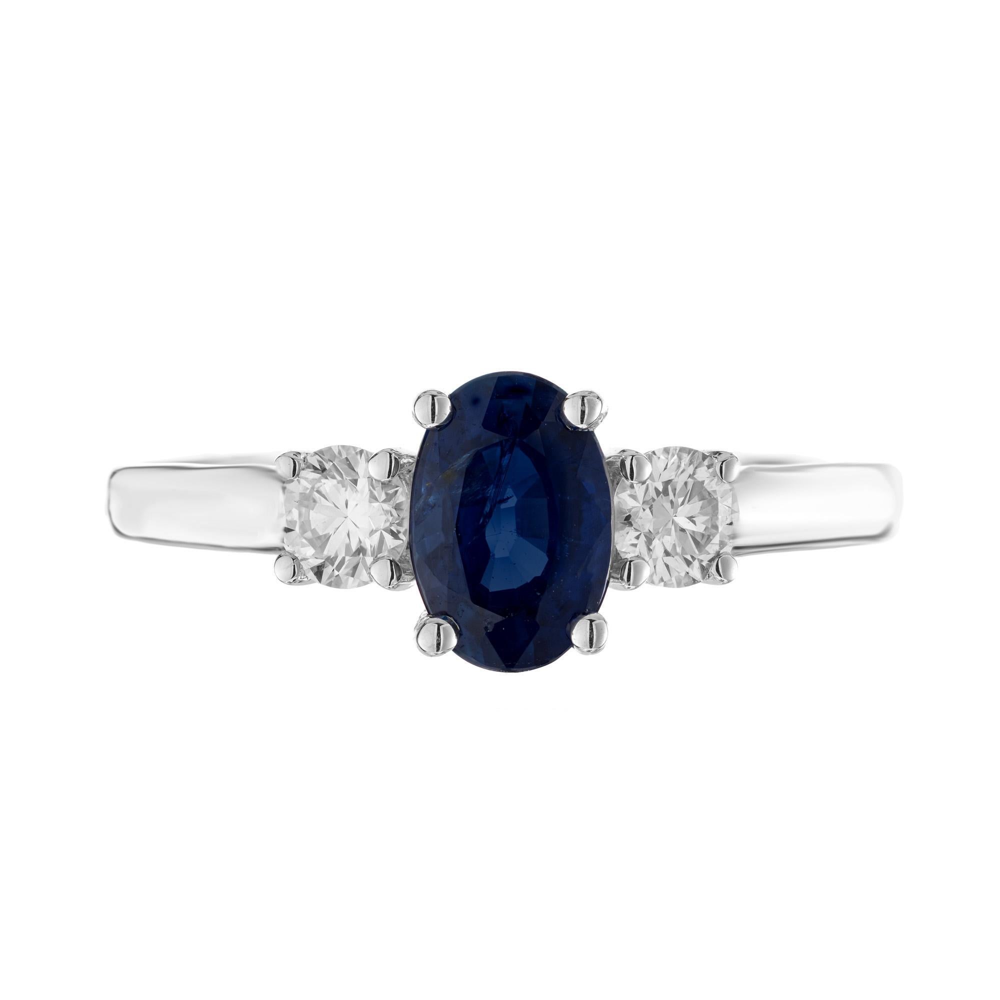 Sapphire and Diamond three stone engagement ring. This simple classic design begins with a GIA certified .97ct oval sapphire mounted in 18k white gold setting. Certified by the GIA as natural, no heat. The sapphire radiates a rich blue warm color.