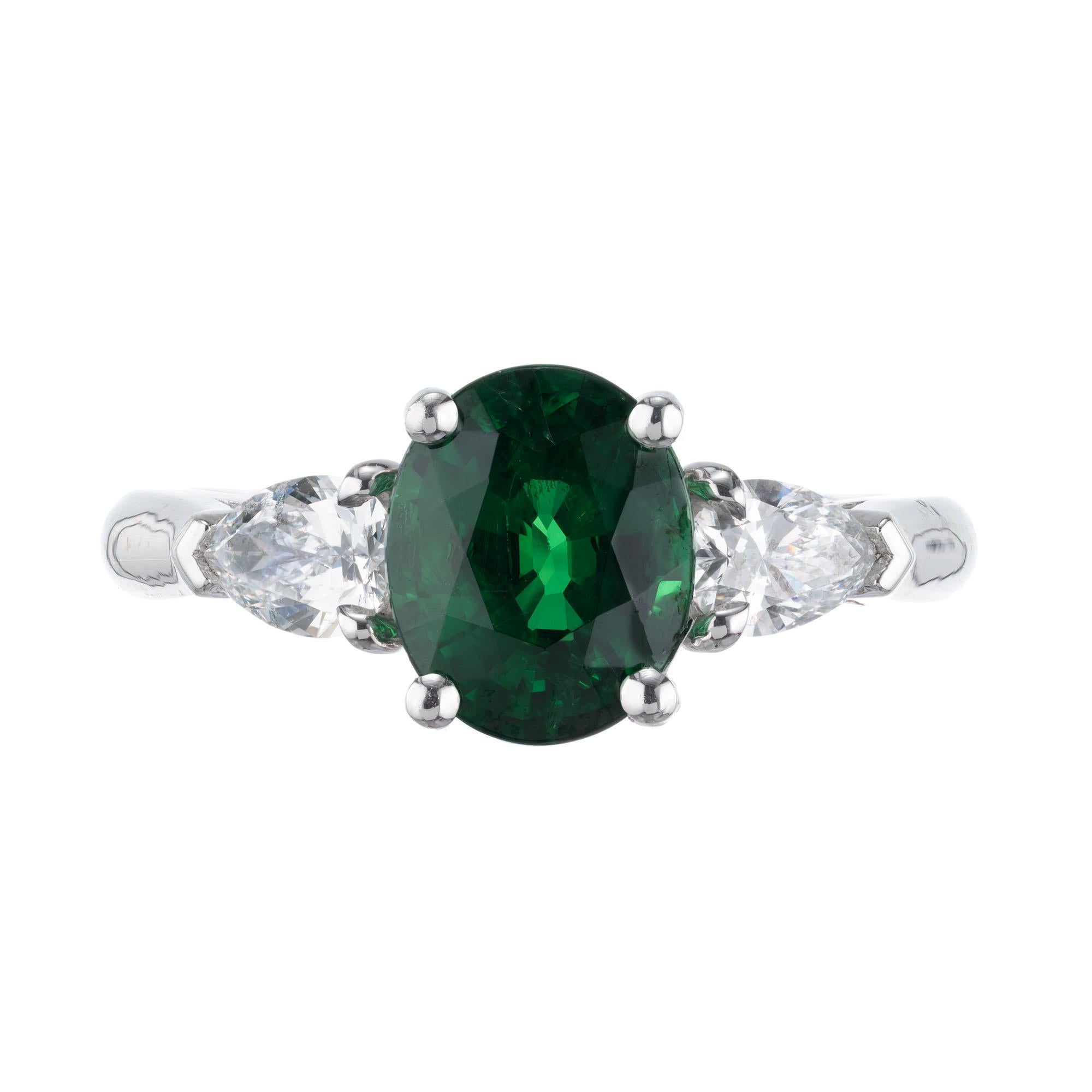 Green Tsavorite Garnet and diamond three-stone engagement ring. 2.30ct oval center stone with two pear shaped side diamonds in a platinum setting. Created in the Peter Suchy Workshop. GIA Certified. 

1 oval bright green Garnet, approx. total weight