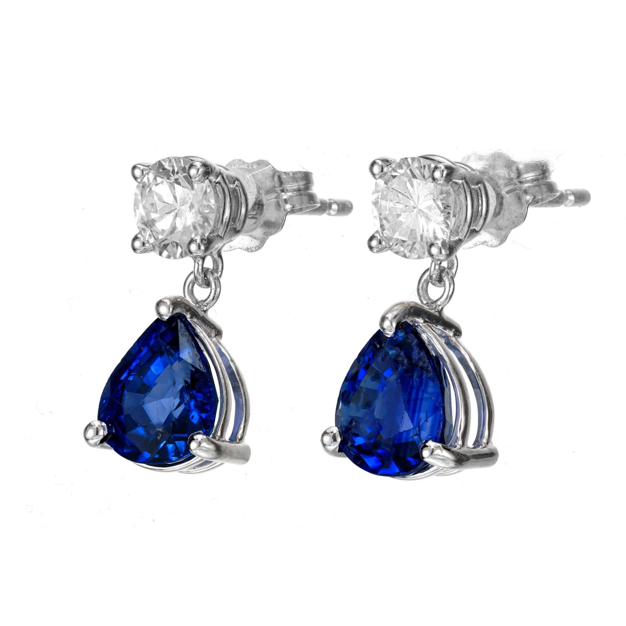 Sapphire and diamond earrings. GIA certified pear shaped sapphires, each dangling from a round shaped diamond in a 14k white gold setting. Designed crafted in the Peter Suchy Workshop. 

1 pear shape blue sapphire, SI approx. 1.20ct GIA certificate