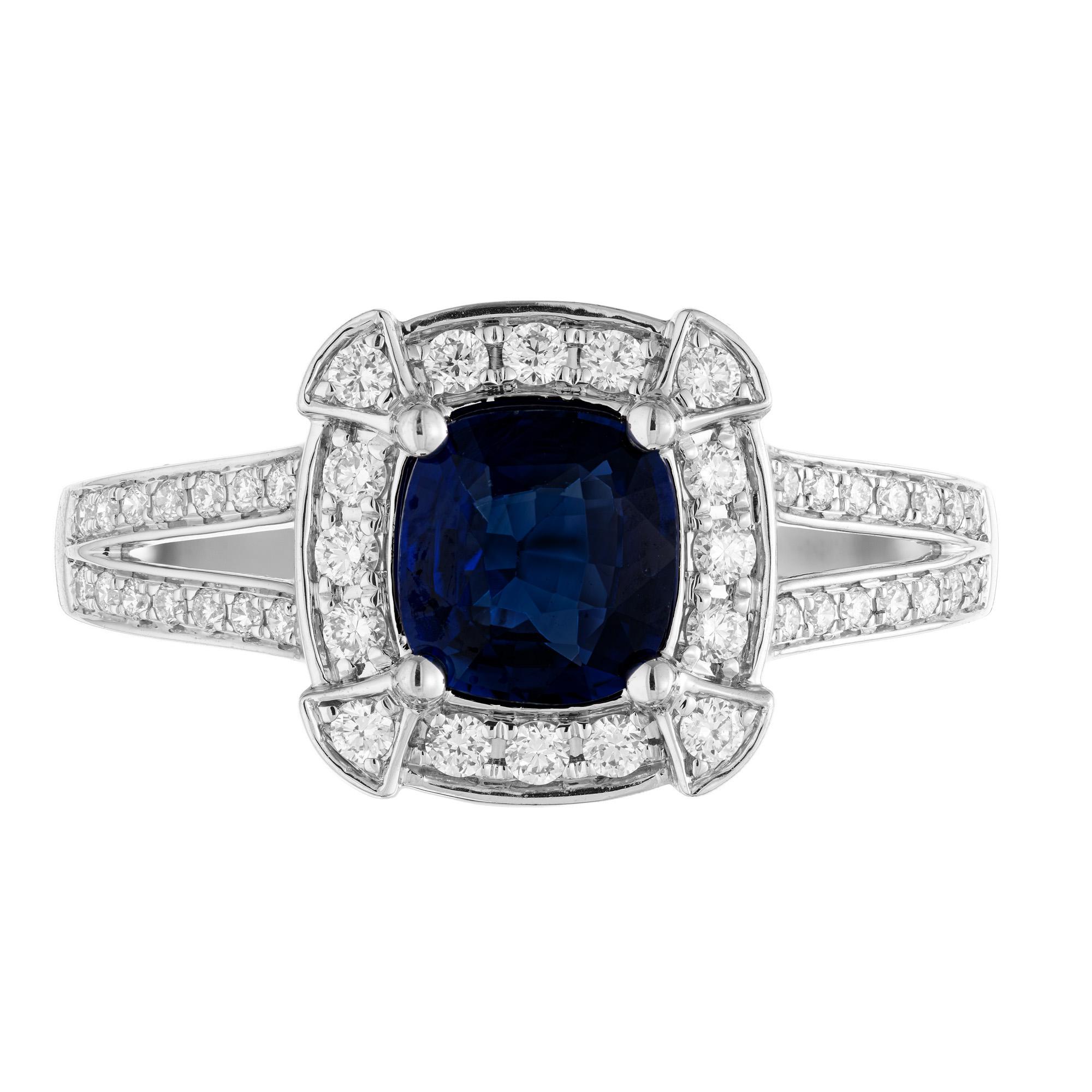 Velvety blue GIA certified cushion cut sapphire and diamond engagement ring. This exquisite piece begins with a 1.01ct cushion cut sapphire, mounted in a 14k white gold split shank setting. The diamond is accented with a halo or round brilliant cut