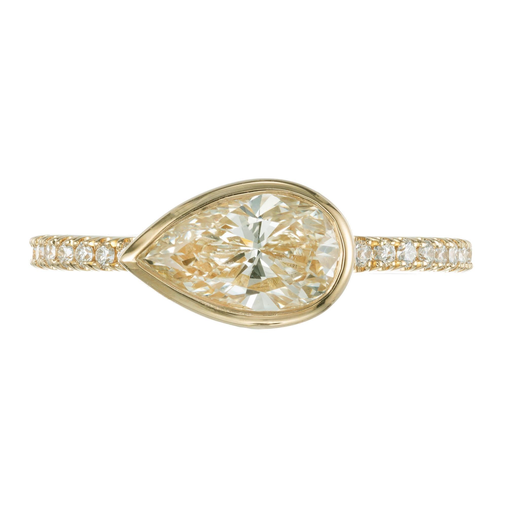 Peter Suchy pear shaped diamond engagement ring. GIA certified light soft yellow center stone in a 18k yellow gold setting with 20 round micro pave accent diamonds. Created in the Peter Suchy Workshop. 

1 pear-shaped light-yellow diamond N SI,