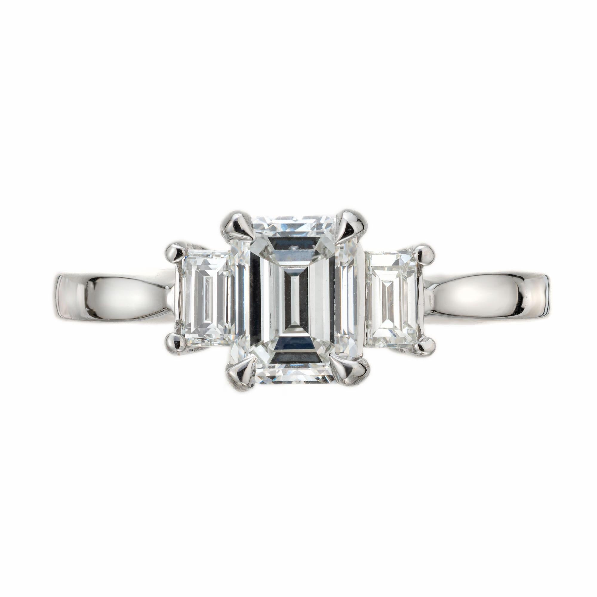 Diamond three-stone engagement ring. GIA Certified emerald cut diamond with 2 emerald cut side diamonds in a platinum setting created in the Peter Suchy Workshop. 

1 emerald cut diamond, G SI2 approx. 1.04cts GIA Certificate # 6203529844
2 emerald