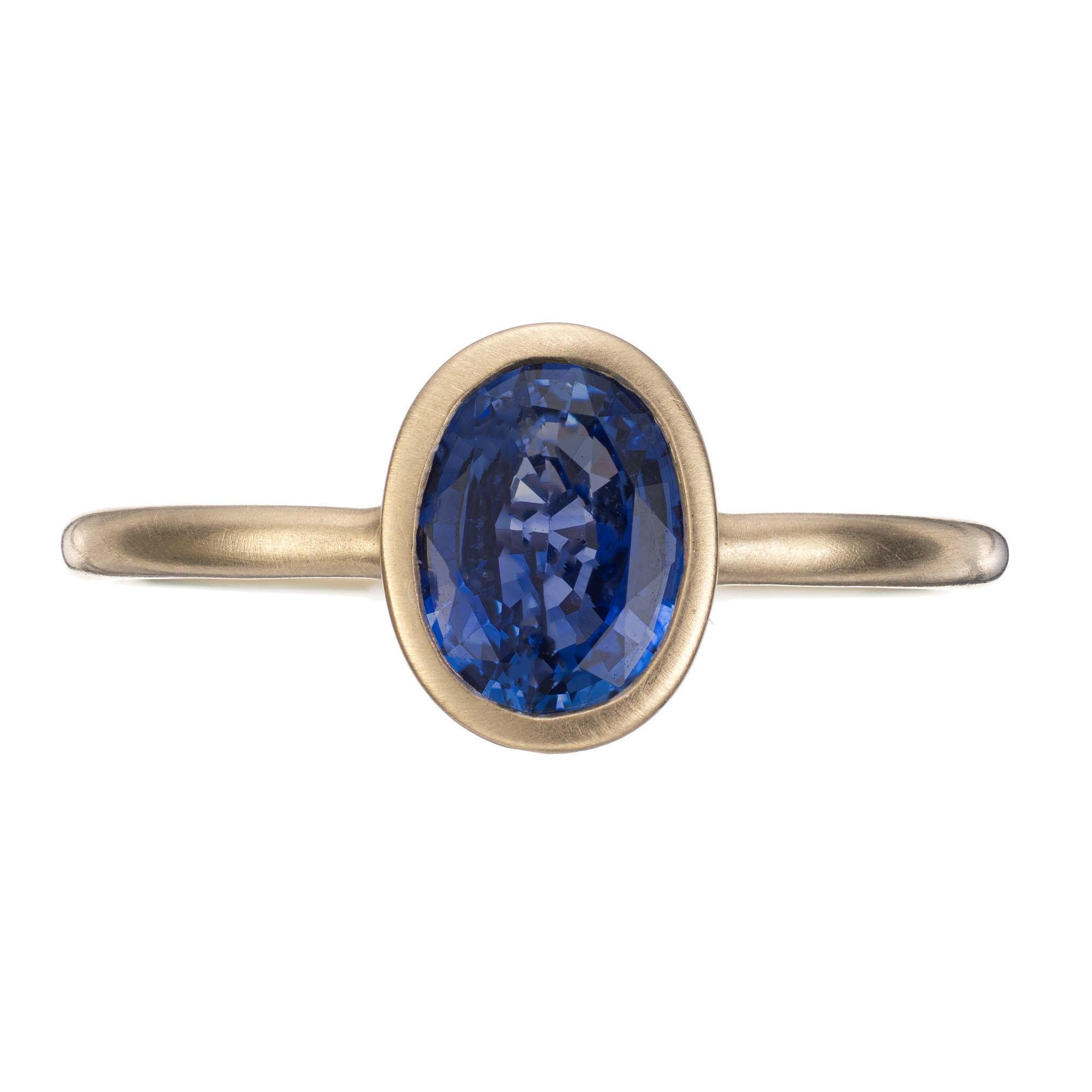 Simple oval Ceylon sapphire solitaire engagement ring. GIA certified bezel set 1.05ct center sapphire in a 14k yellow gold handmade matte finish setting. GIA has certified the sapphire as simple heat only. An alternative to the classic engagement