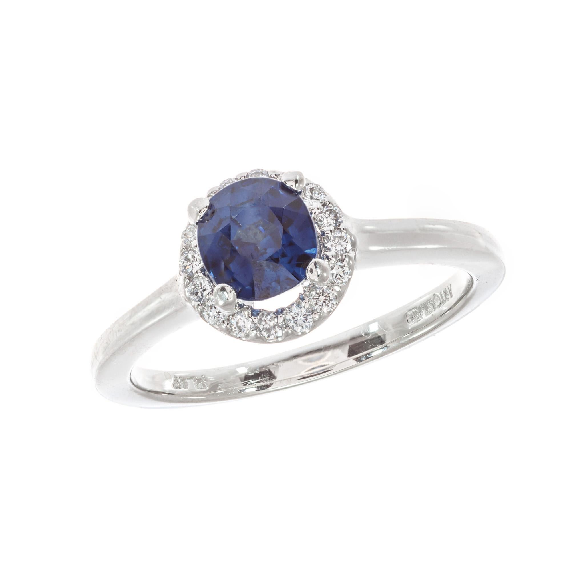 Blue sapphire and diamond engagement ring. GIA certified natural no heat no enhancements center stone in at platinum diamond halo setting. Designed in the Peter Suchy Workshop. 

1 cushion cut rich blue SI sapphire Approximate 1.05cts GIA