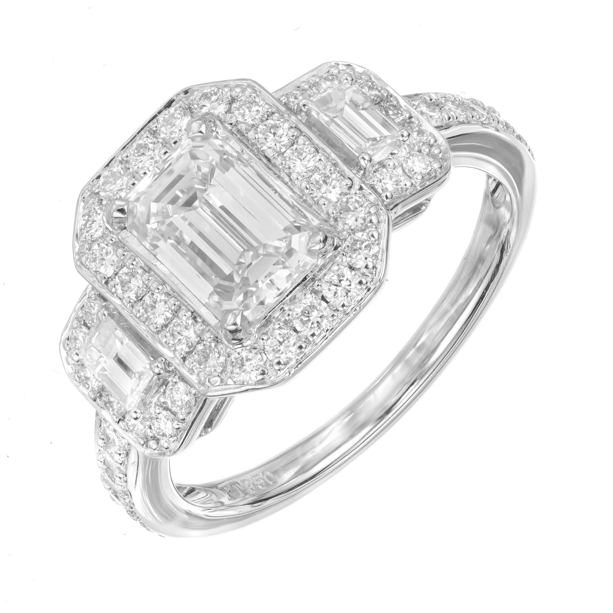 Diamond three-stone engagement ring. GIA certified center emerald cut 1.08ct diamond with 2 emerald cut side stones. Each stone has a halo of round brilliant cut diamonds that are also along the shank. The 3 stones are from a 1920's estate. The ring