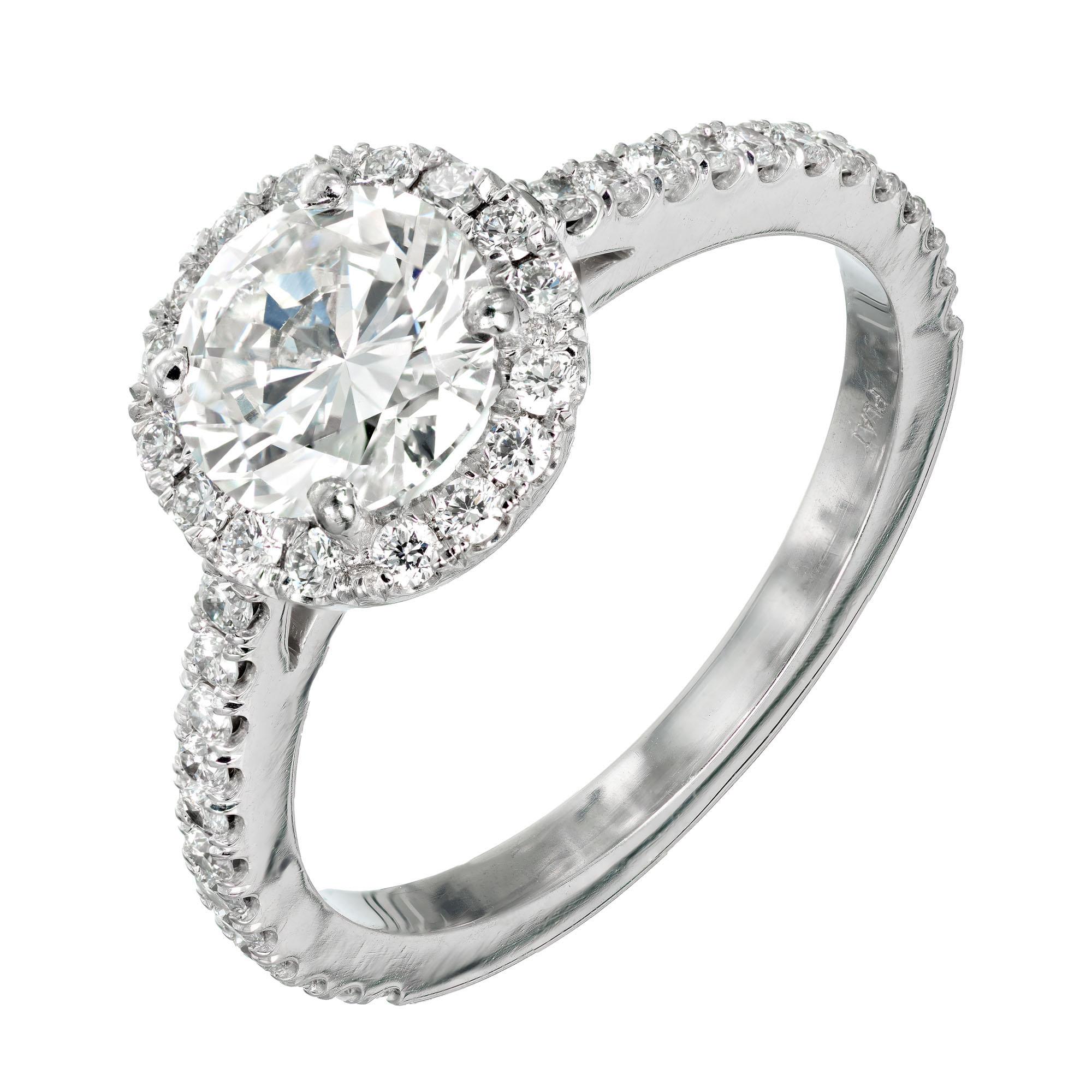 Peter Suchy round brilliant cut diamond ring. GIA certified center stone with a halo of round diamonds in a platinum solitaire setting. Specially set low to the hand for comfort with the side designed to fit a wedding band flush to the ring. 

1
