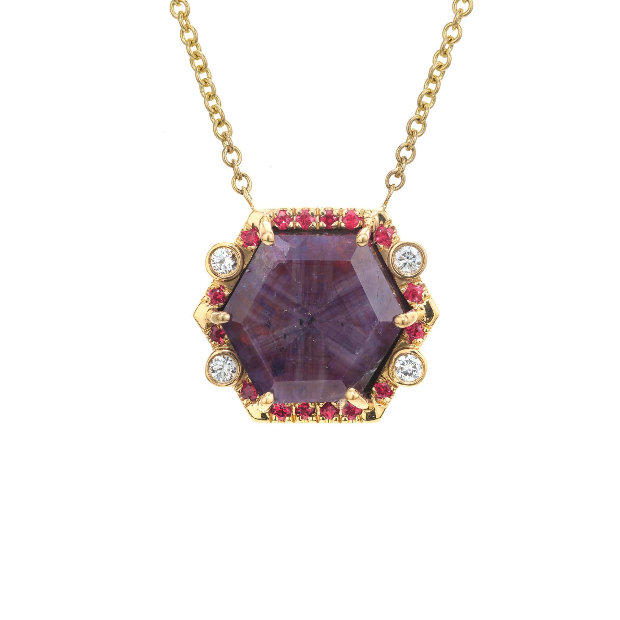 Ruby and diamond pendant necklace. GIA certified 11.71ct natural untreated 8 sided Trapiche ruby set in 18k yellow gold setting with a halo of 16 round red rubies and 4 round bezel set diamonds. 18 inch yellow gold chain. Truly a unique piece that