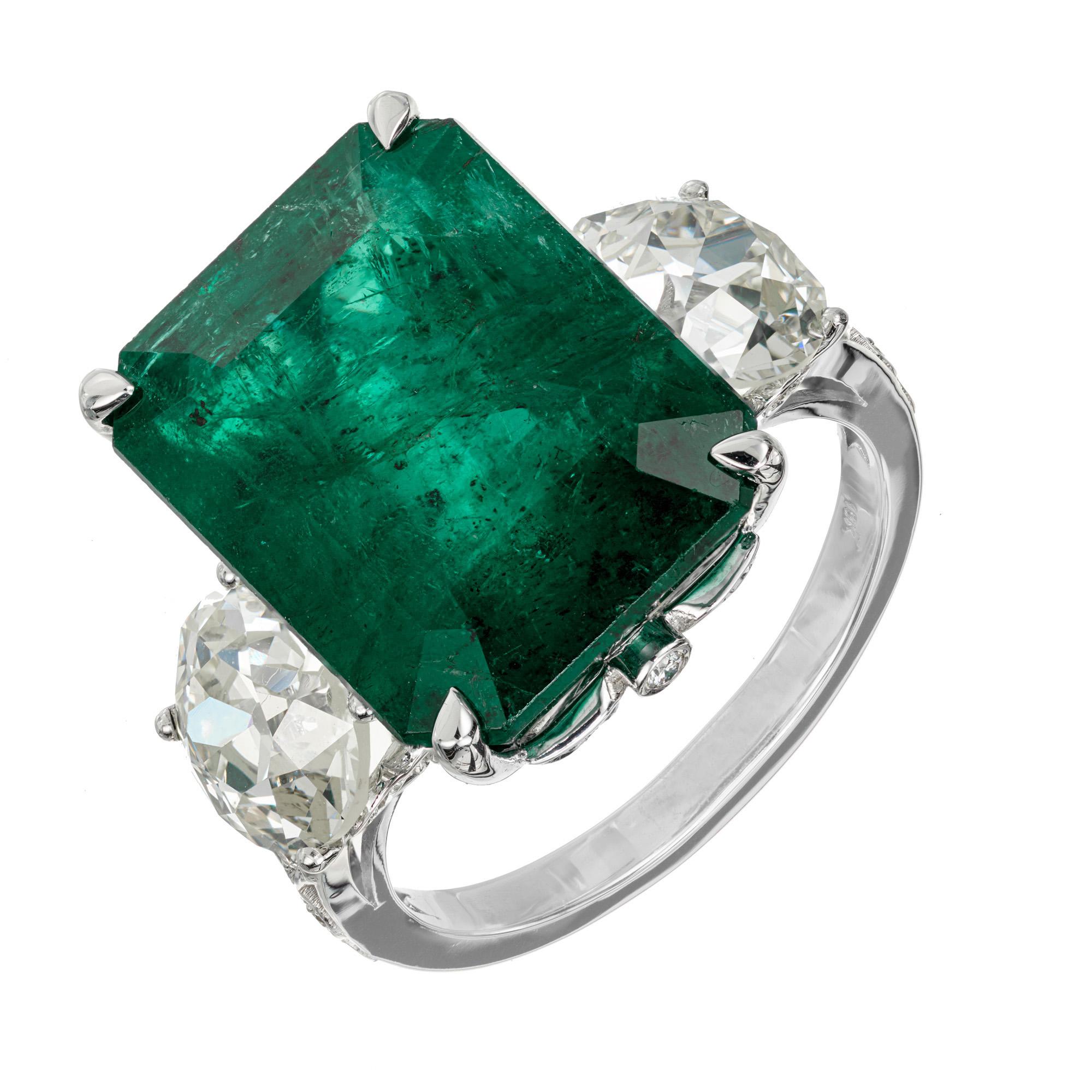 Awe inspiring 11.89 genuine emerald and diamond ring. GIA certified natural 11.89ct emerald with moderate clarity in a 18k white gold three-stone setting with 2 GIA certified old European round cut side diamonds totaling 3.10cts. The original
