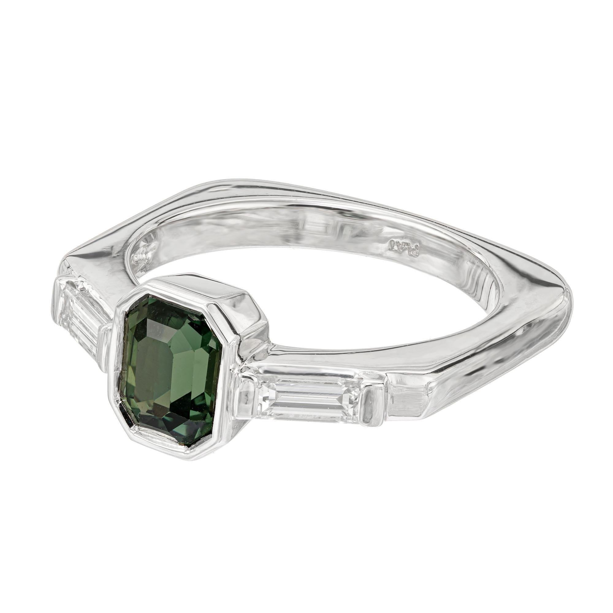 Sapphire and diamond three stone engagement ring. GIA certified octagonal green center sapphire with 2 straight cut baguette diamonds, set in platinum. Natural untreated green sapphire from a 1920's estate. Designed and crafted in the Peter Suchy